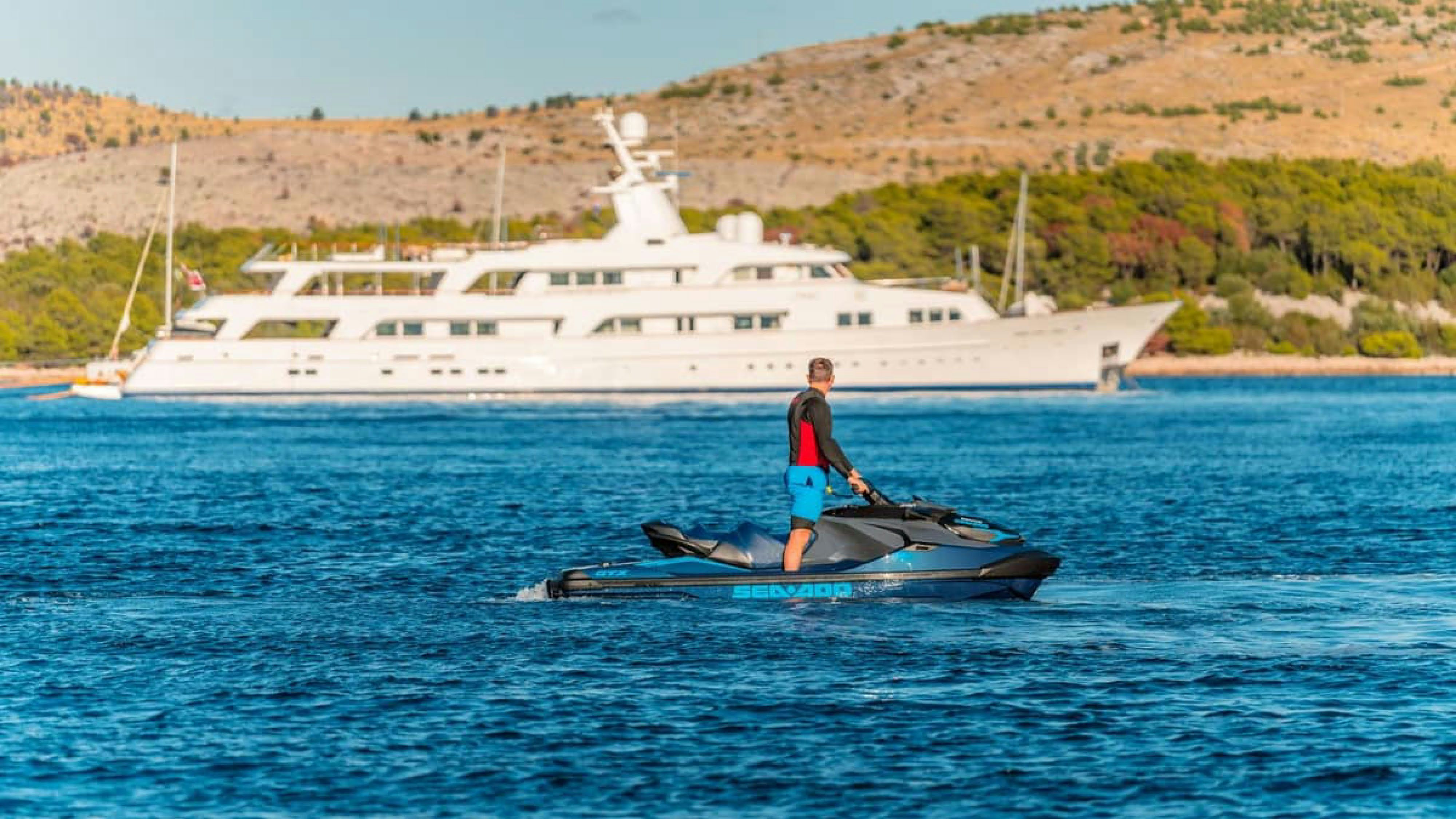 a person standing on a boat in the water aboard VICTORY Yacht for Charter