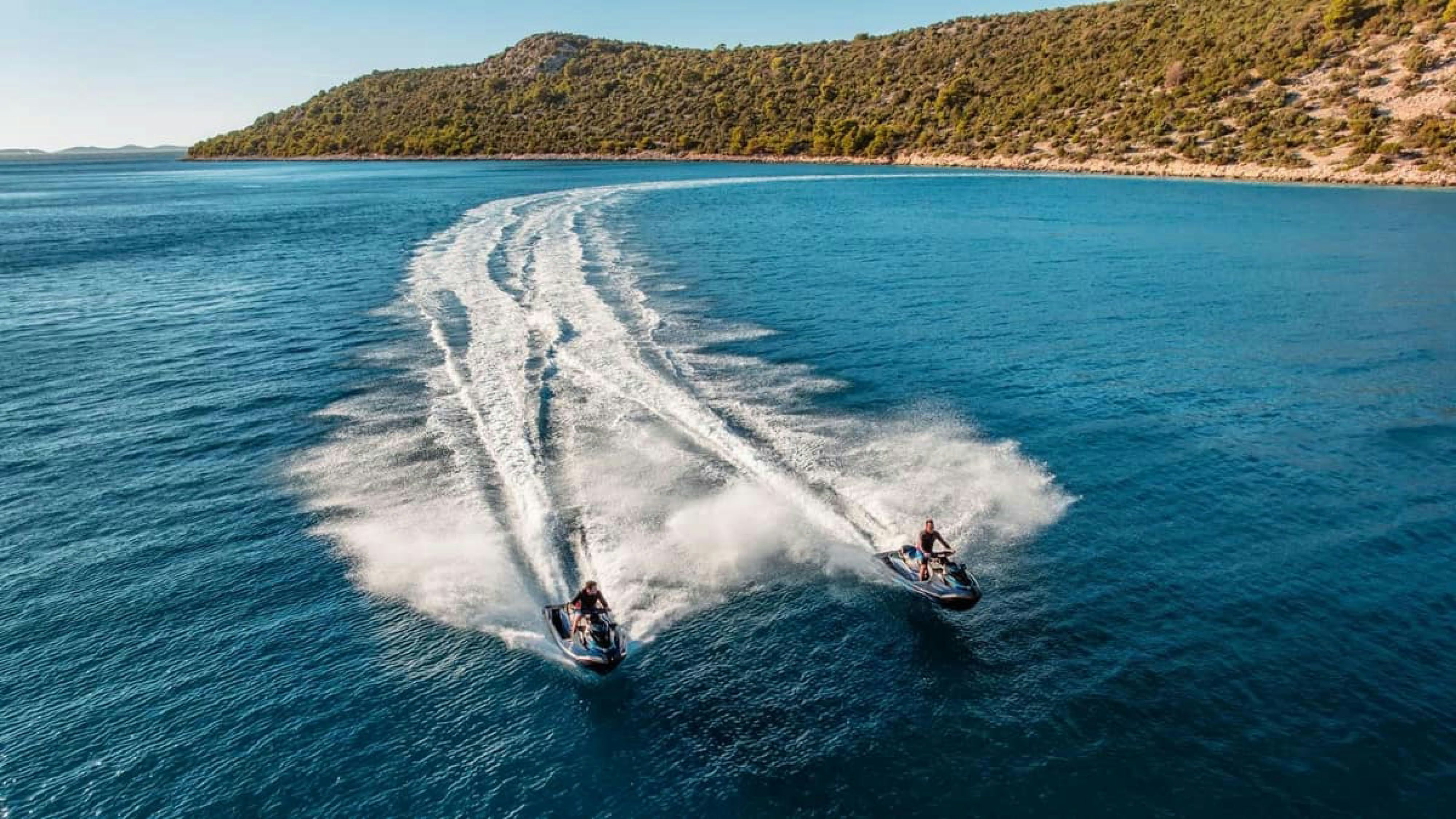 a couple of people surfing on the sea aboard VICTORY Yacht for Charter