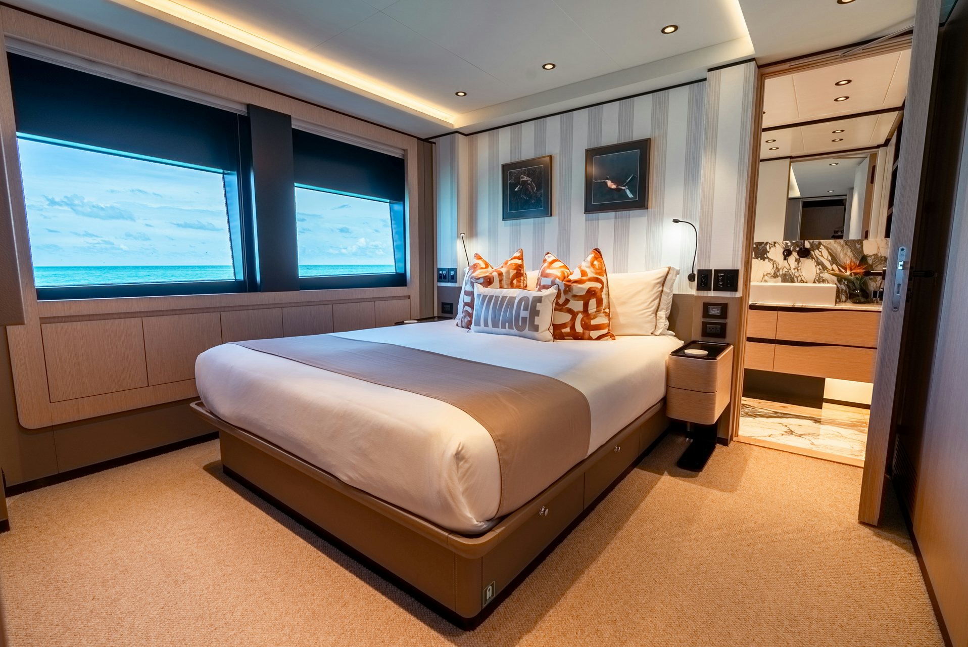 a bedroom with a bed and a window aboard VIVACE Yacht for Charter