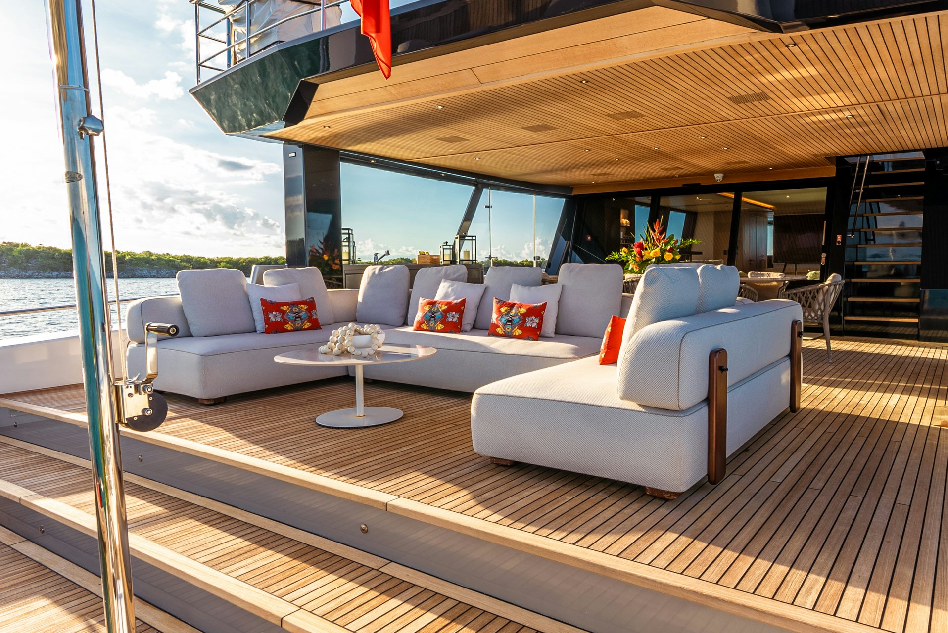 a living room with a large white couch and a large window aboard VIVACE Yacht for Charter