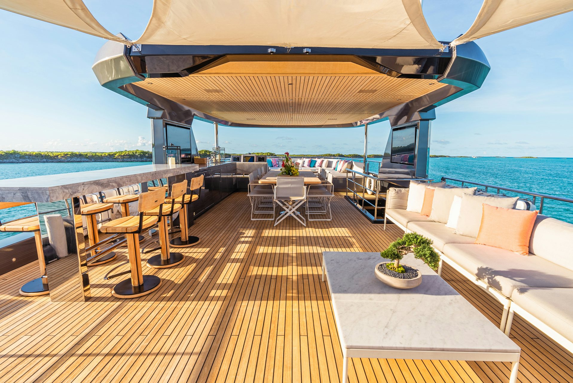 a deck with a table and chairs on it aboard VIVACE Yacht for Charter