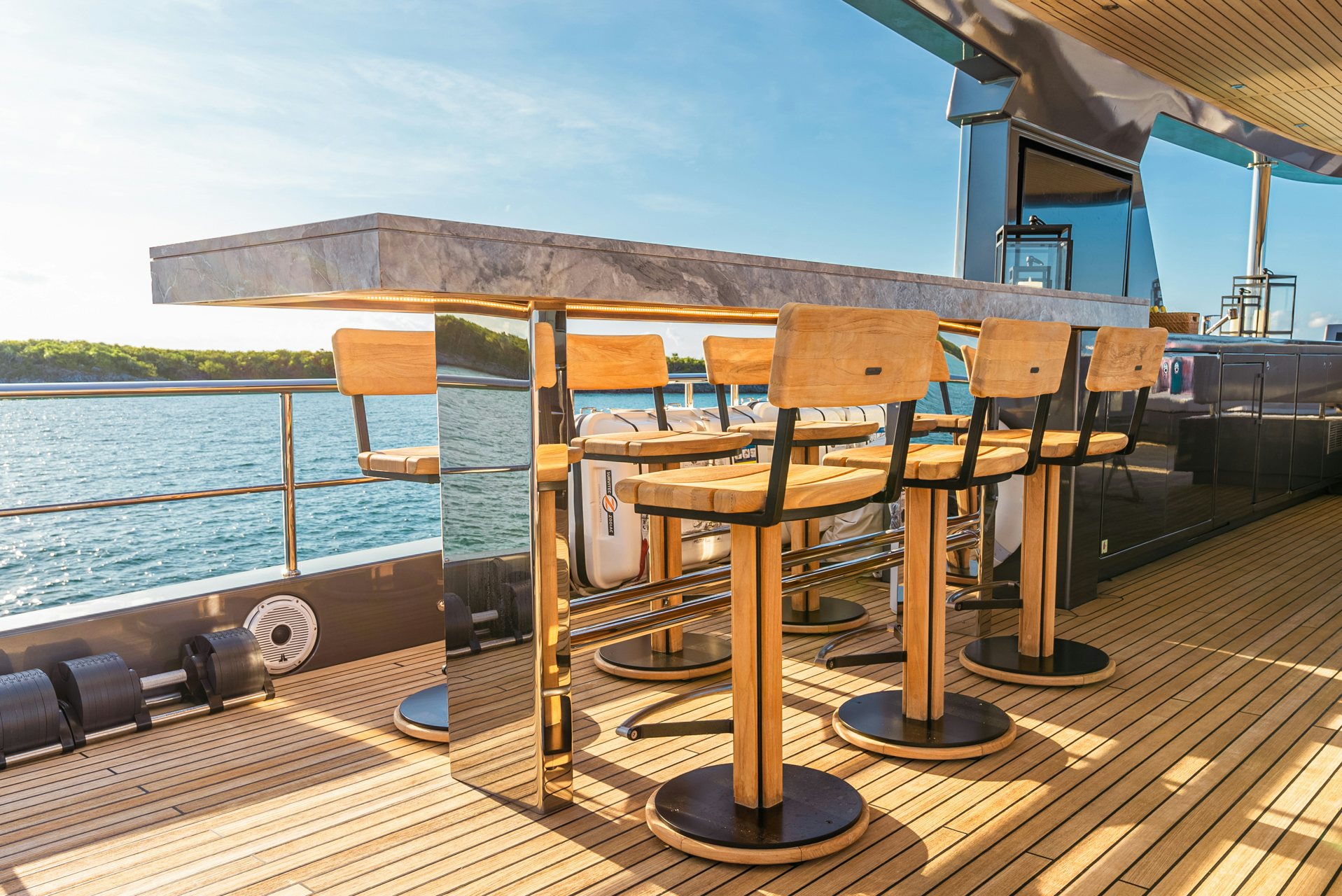 a deck with chairs and a table on it aboard VIVACE Yacht for Charter