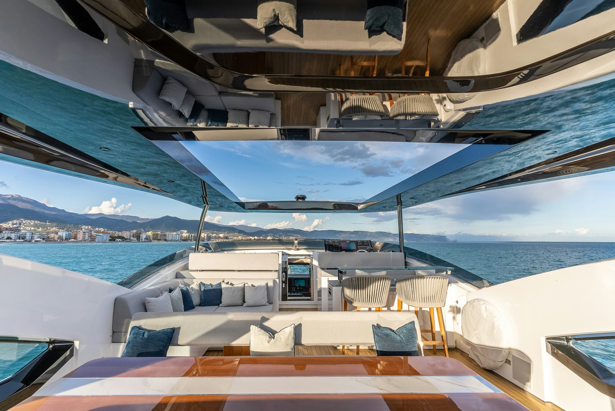 a deck with chairs and a body of water in the background aboard CADET V Yacht for Sale