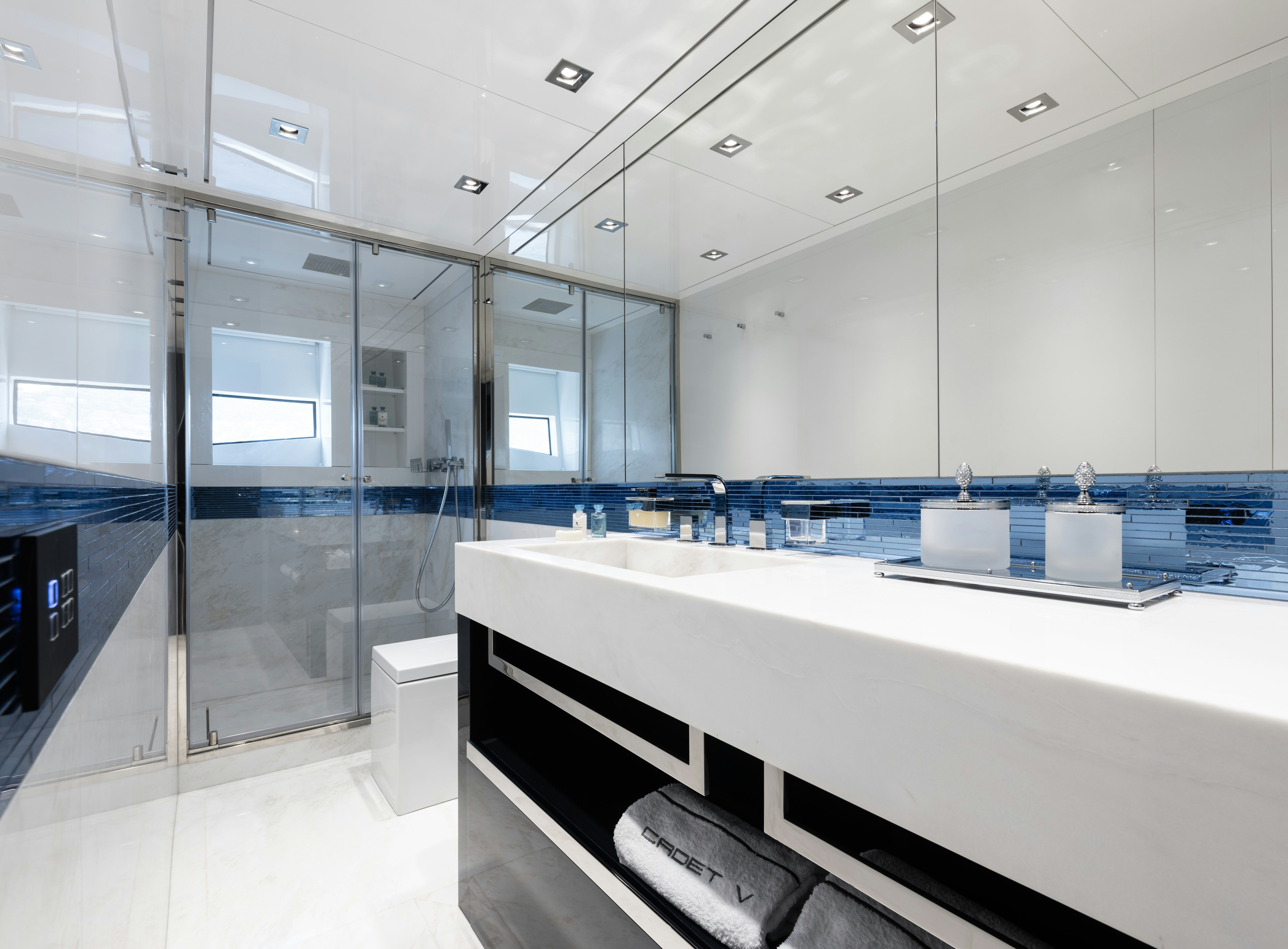 a large bathroom with glass walls aboard CADET V Yacht for Sale