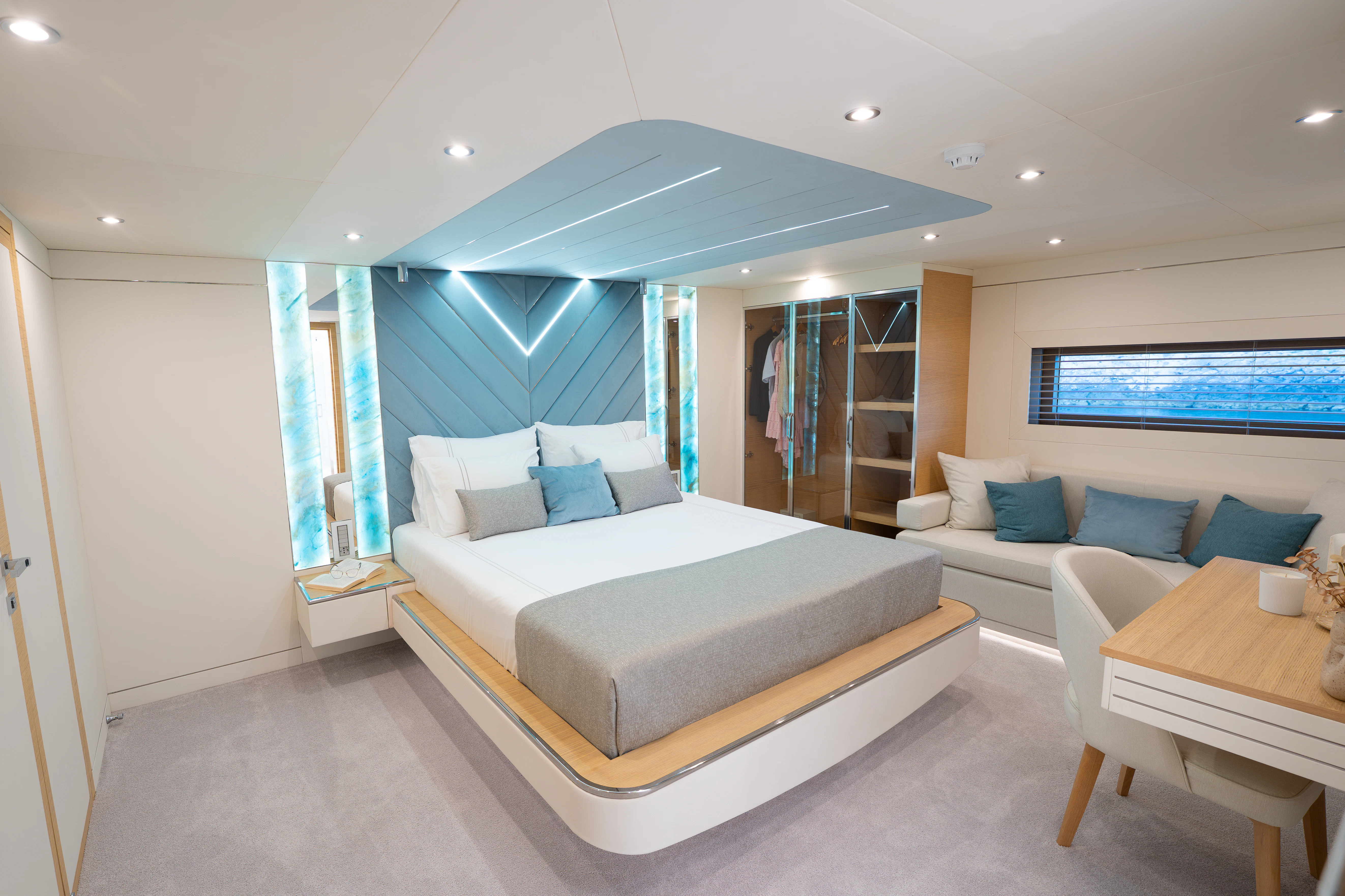 a room with a bed and a table aboard RENATA Yacht for Charter