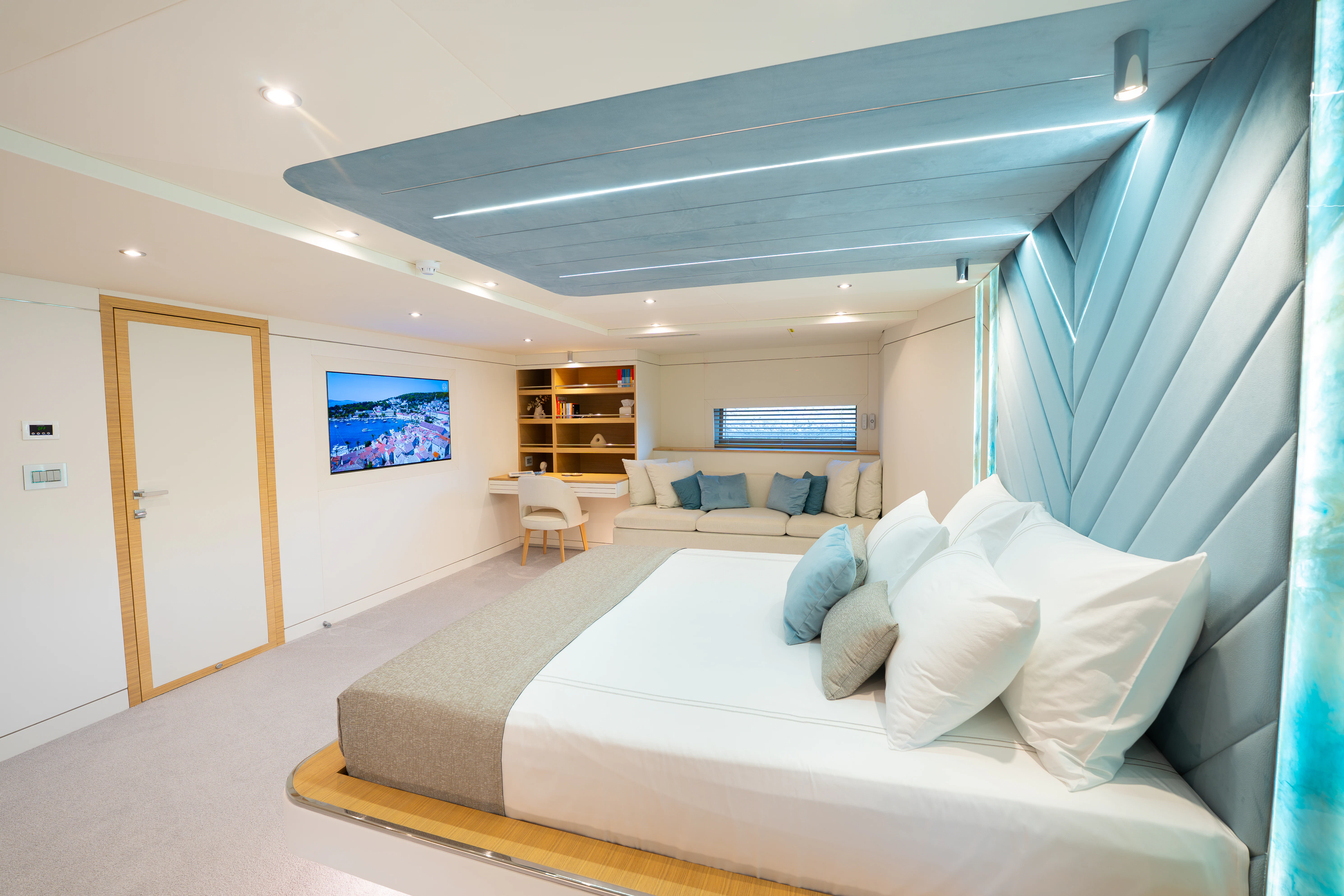 a room with a bed and a couch aboard RENATA Yacht for Charter