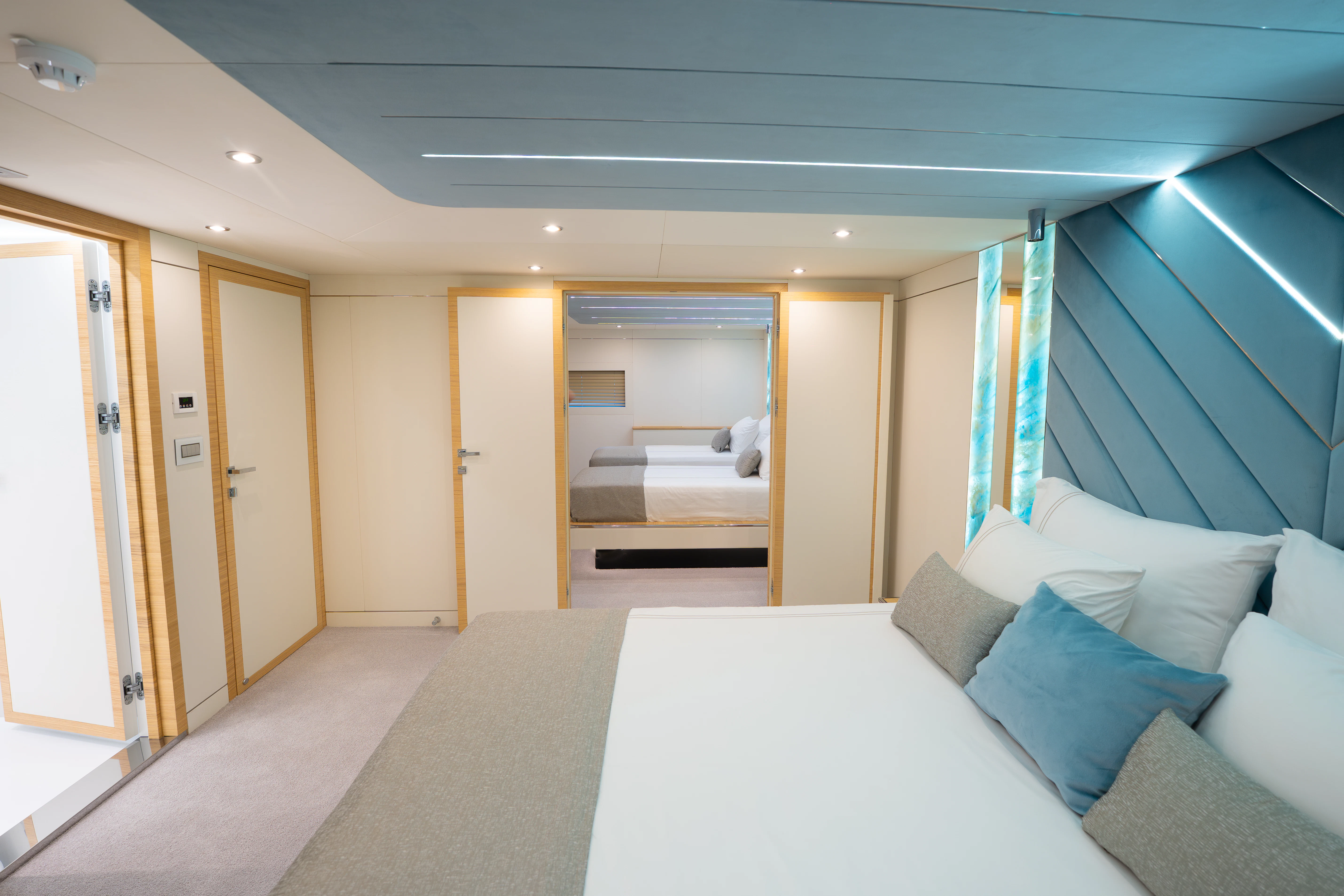 a room with a bed and a large mirror aboard RENATA Yacht for Charter