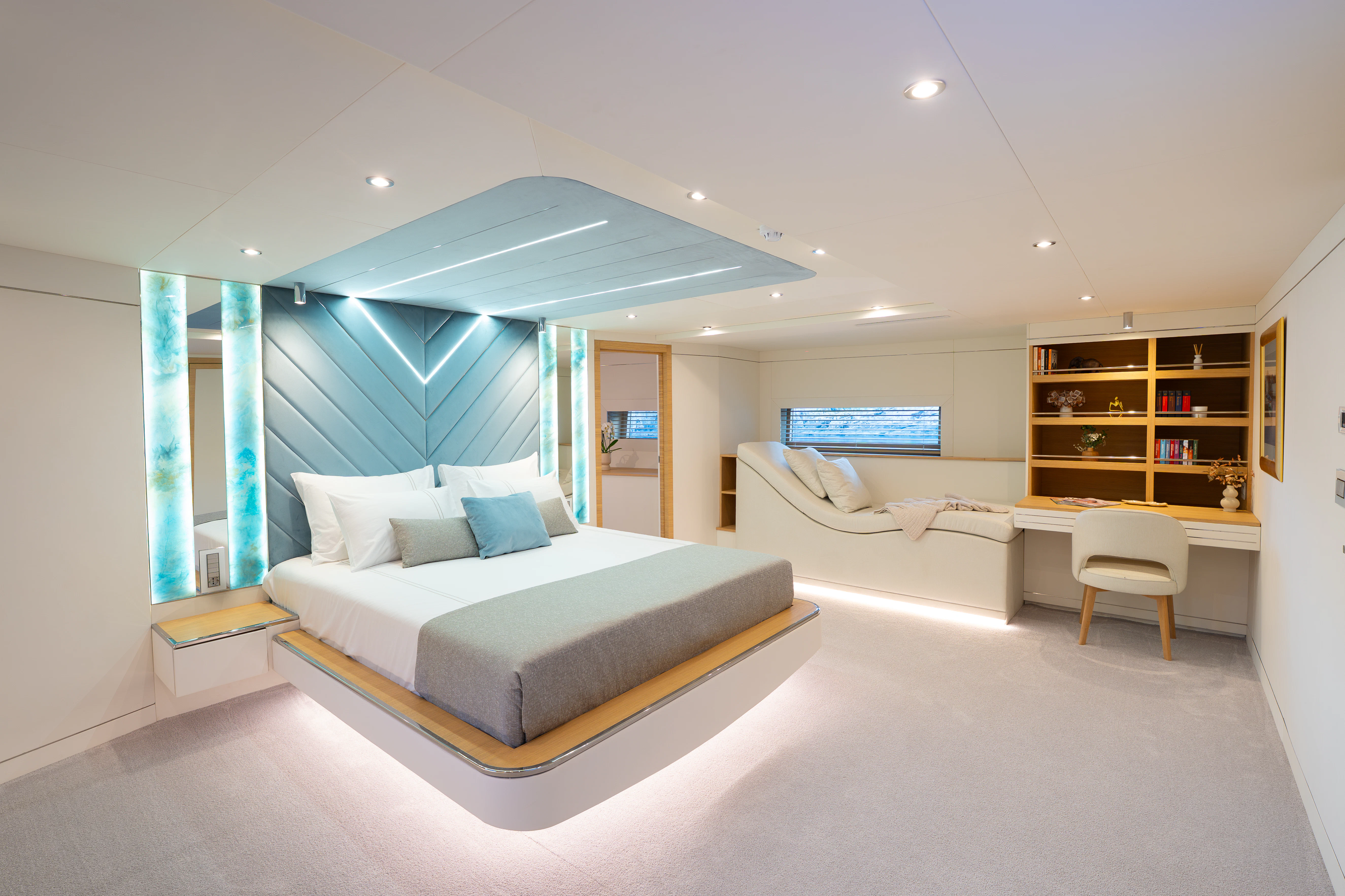 a large room with a bed and a desk aboard RENATA Yacht for Charter