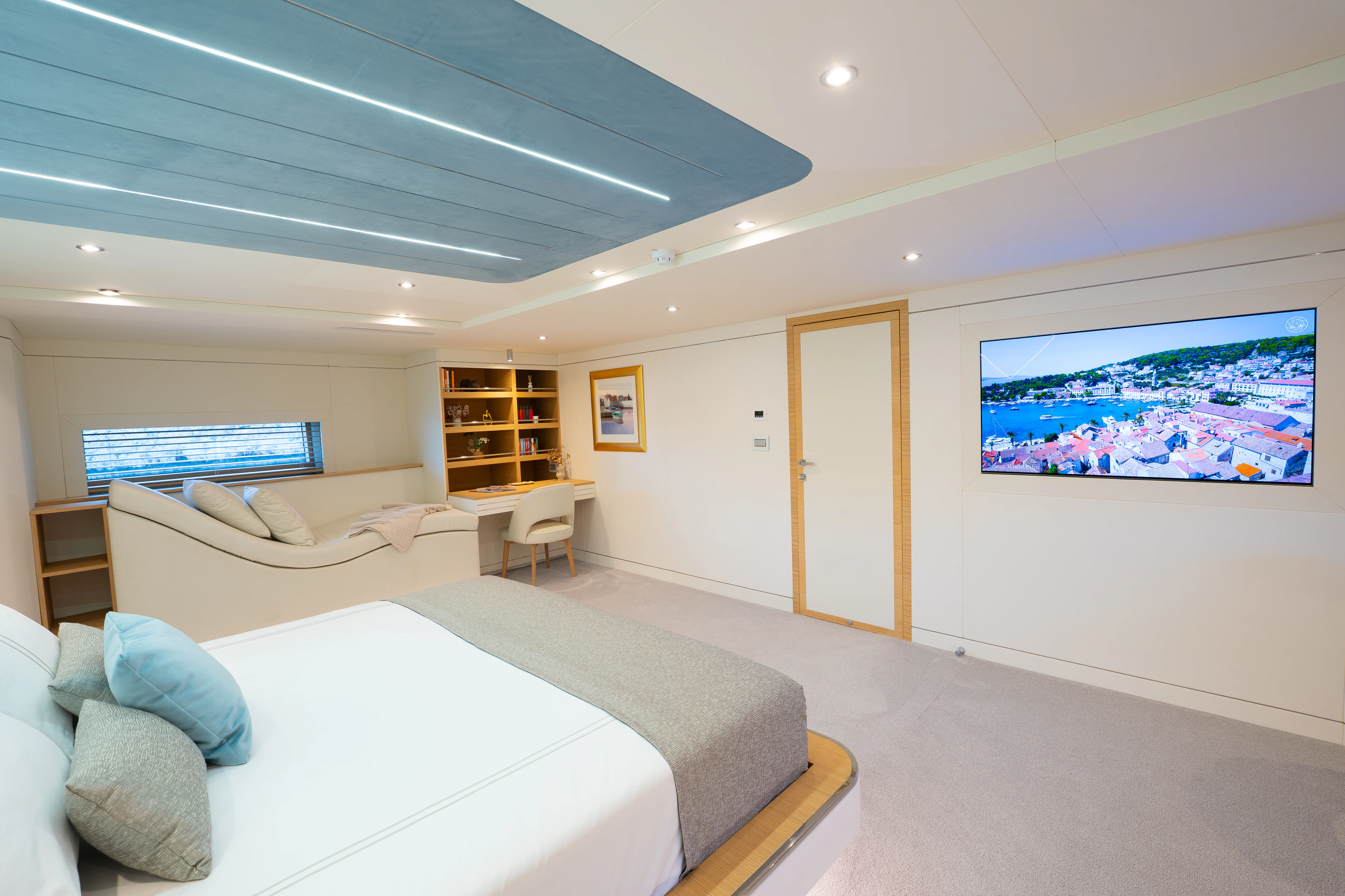 a large white room with a bed and a couch aboard RENATA Yacht for Charter