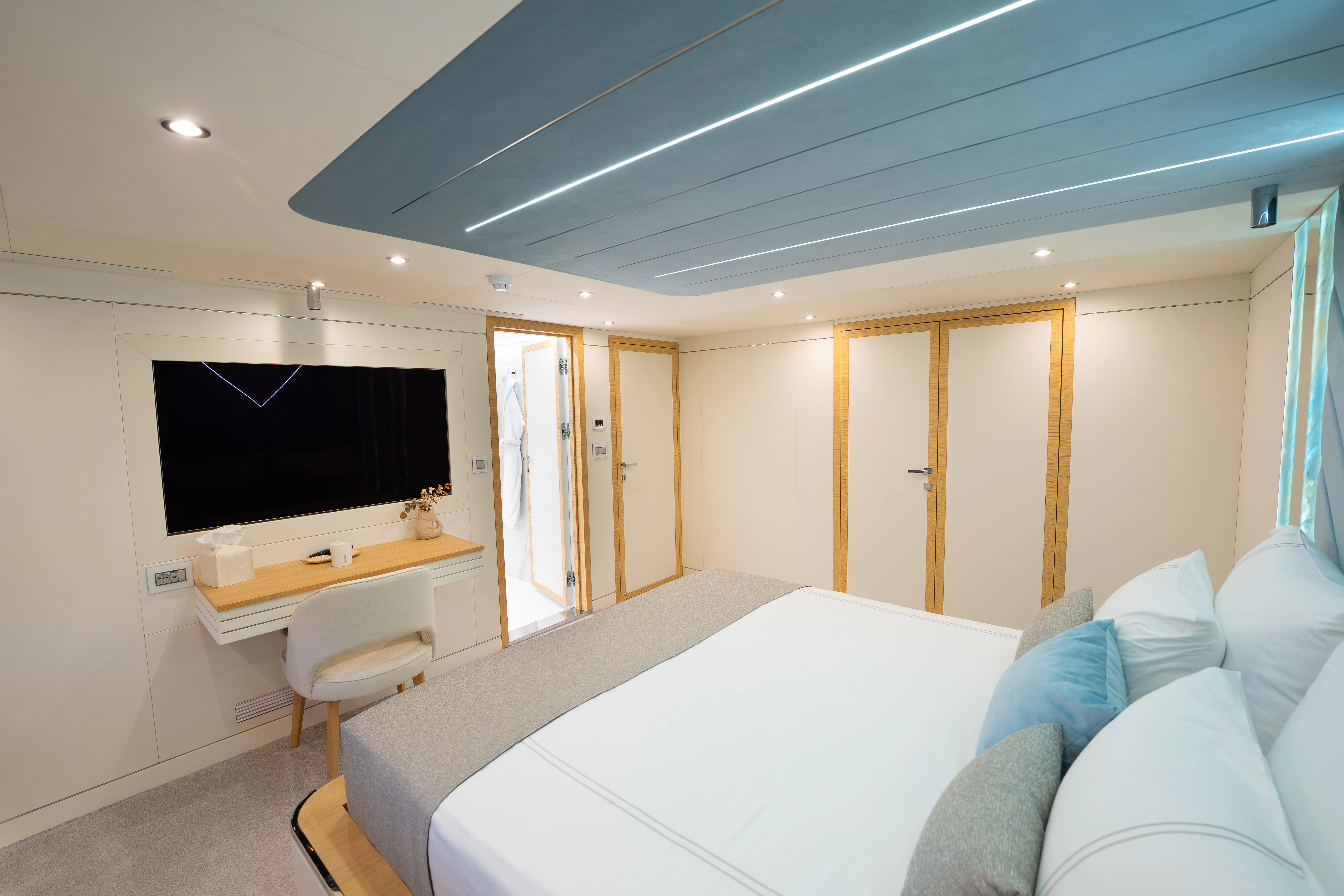 a bedroom with a bed and a television aboard RENATA Yacht for Charter