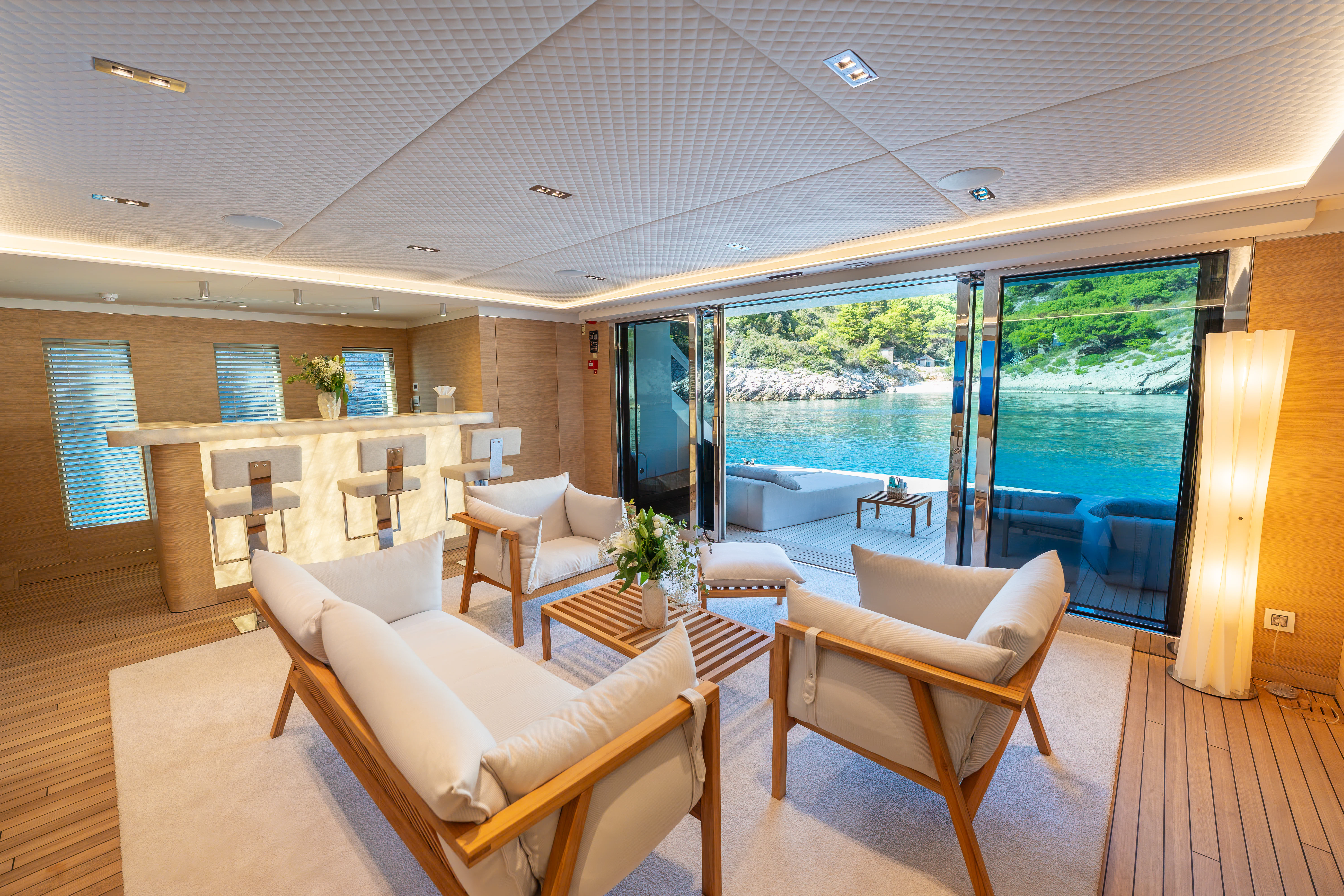 a room with a table chairs and a large window aboard RENATA Yacht for Charter
