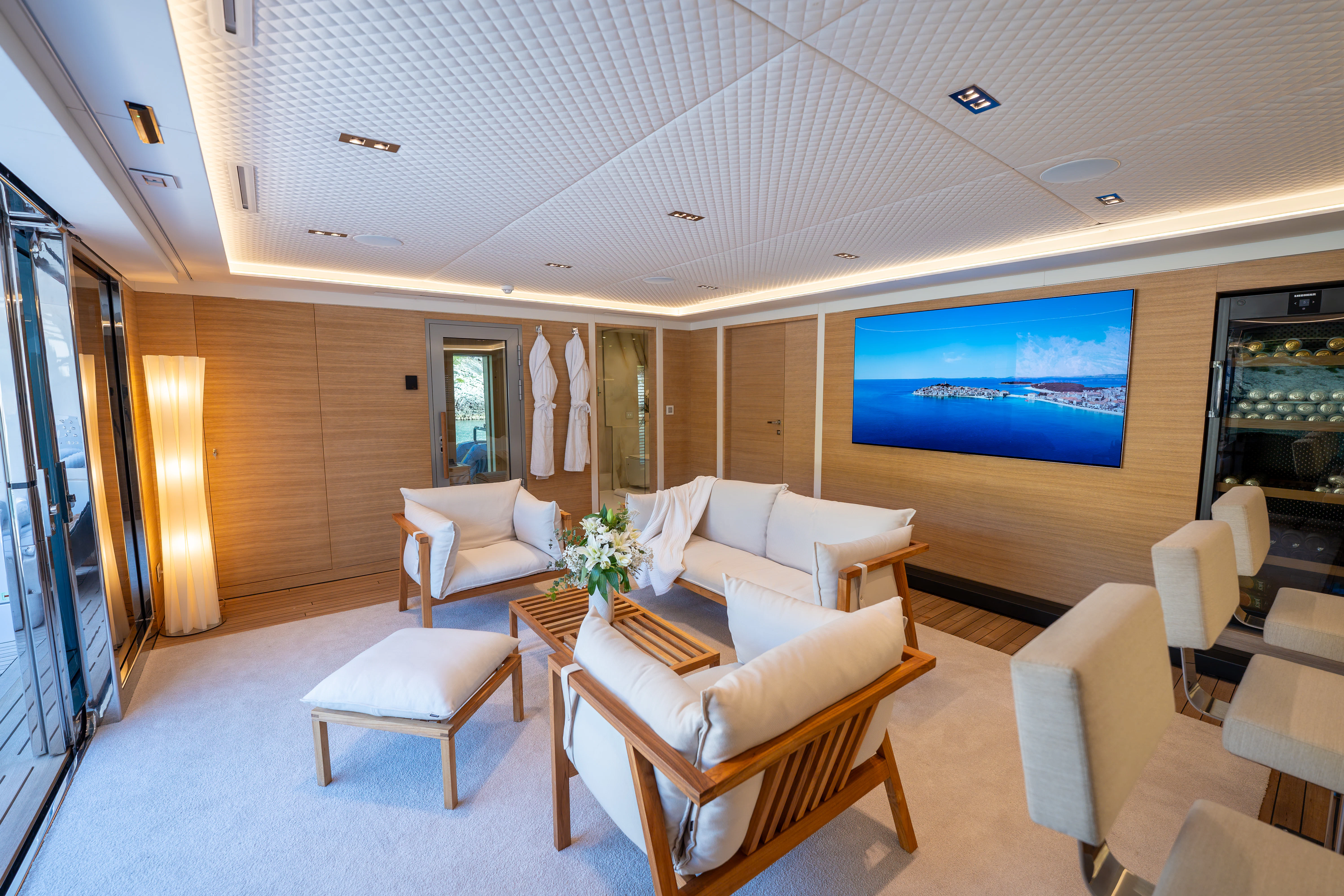 a room with chairs and tables aboard RENATA Yacht for Charter