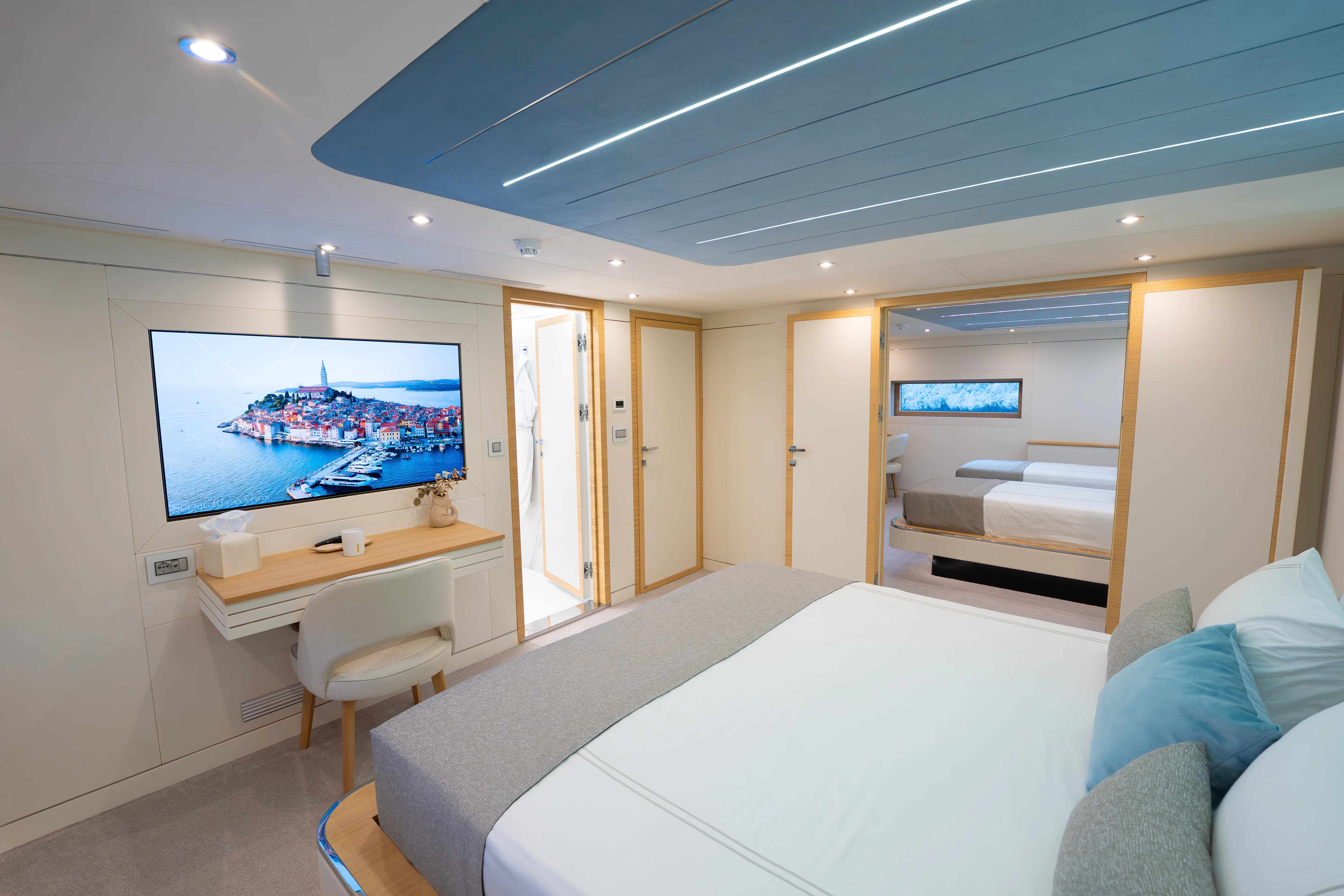a room with a bed and a tv on the wall aboard RENATA Yacht for Charter