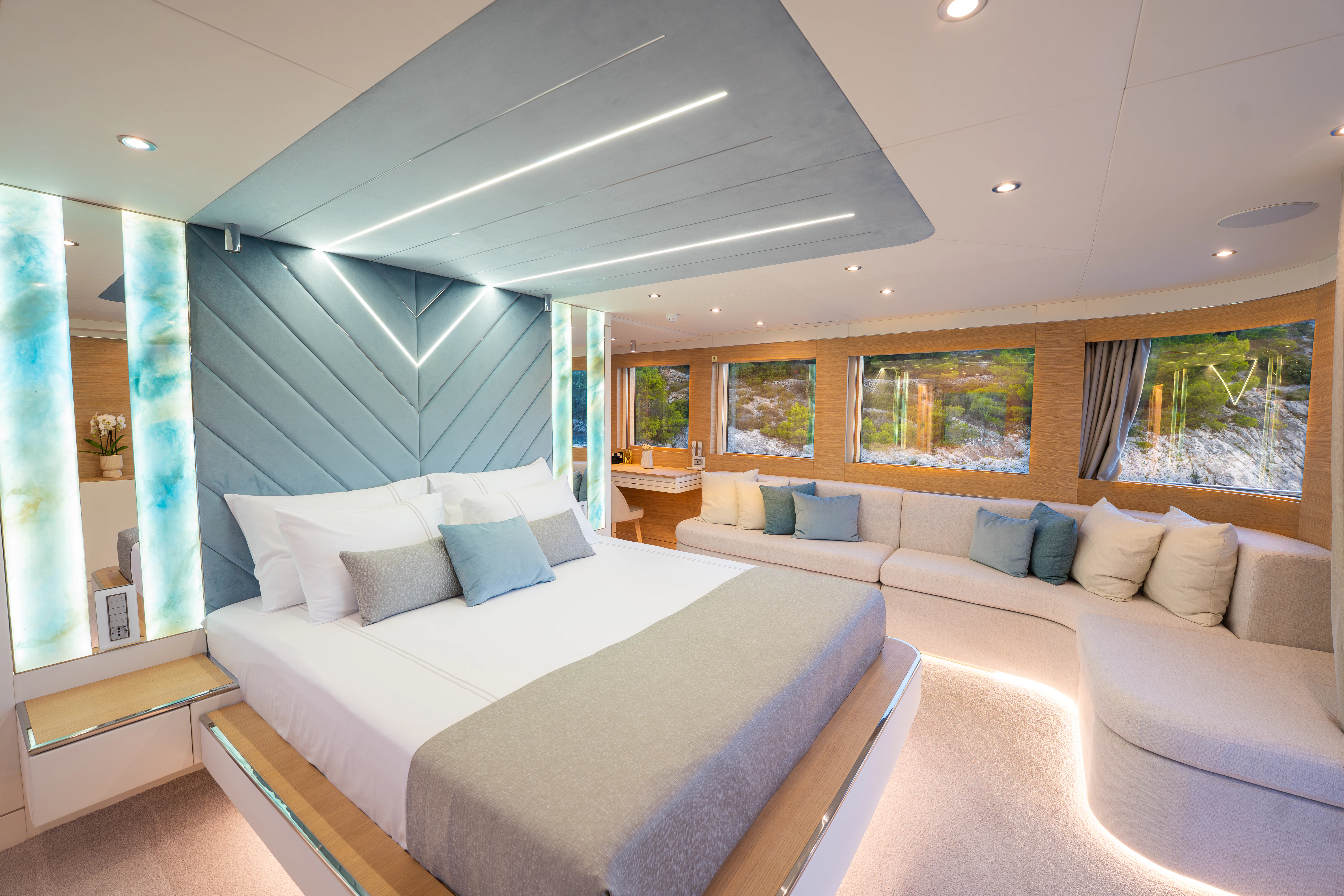 a room with a bed and a couch aboard RENATA Yacht for Charter