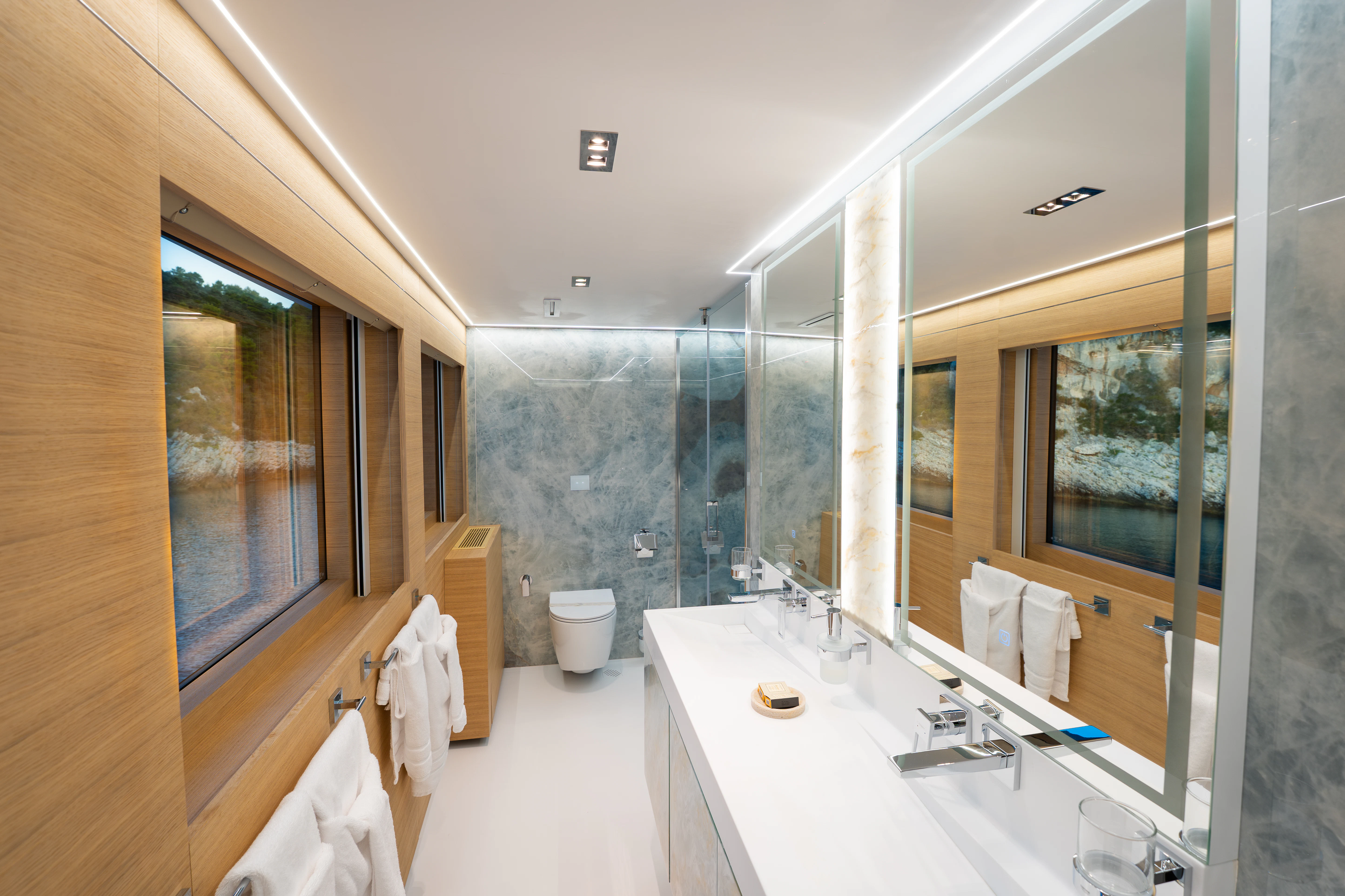 a bathroom with a large mirror aboard RENATA Yacht for Charter
