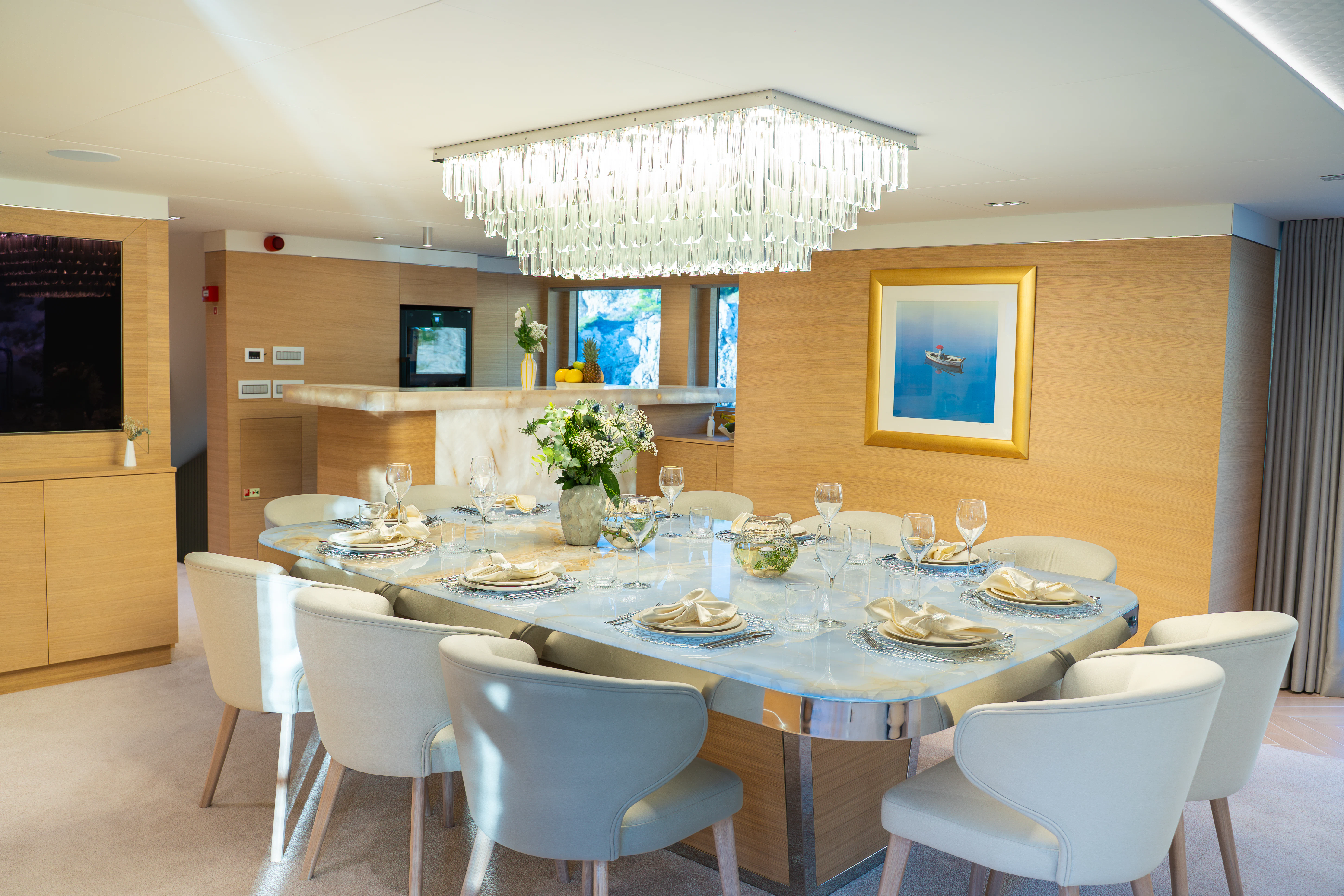 a dining room with white chairs aboard RENATA Yacht for Charter