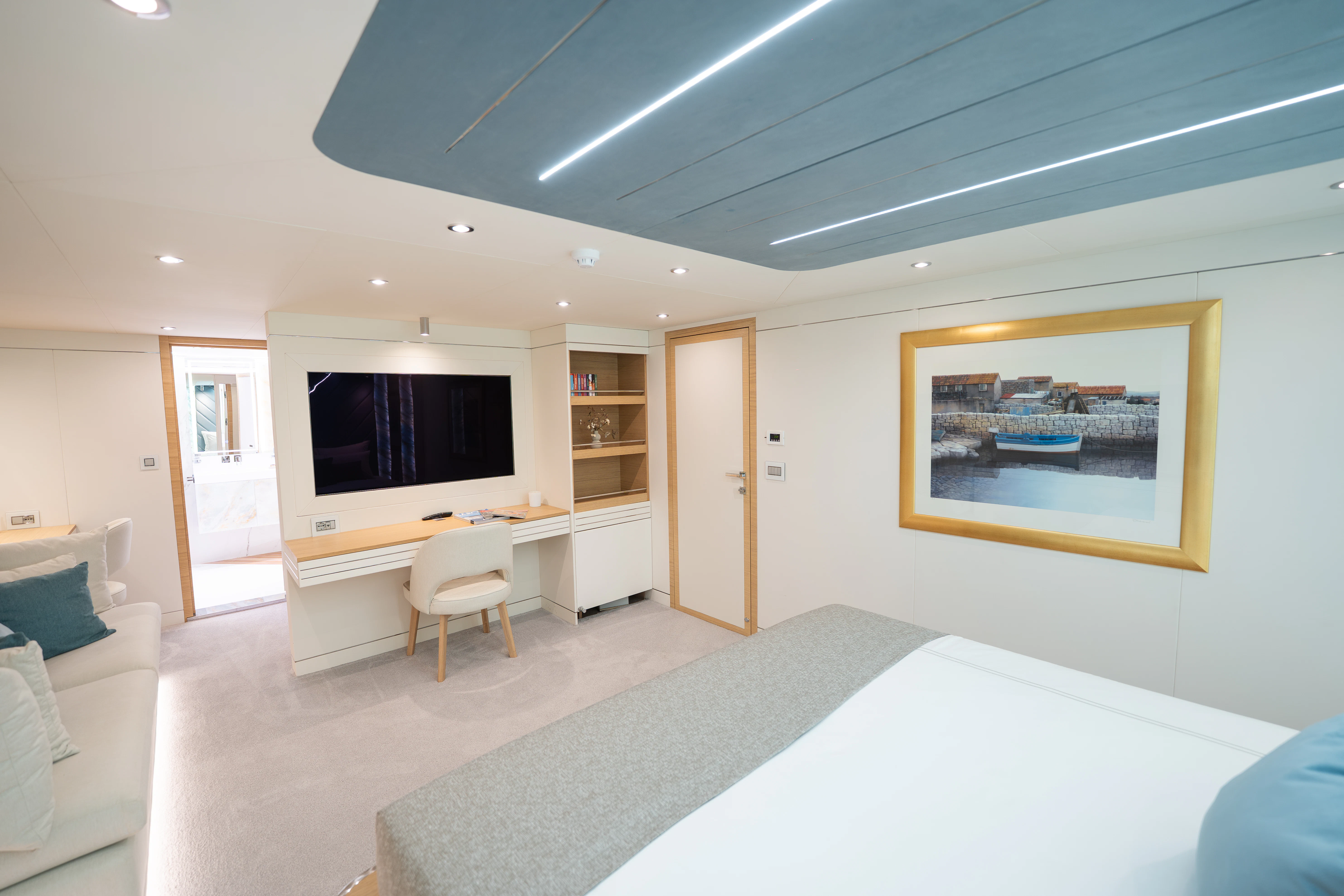 a room with a tv and a table aboard RENATA Yacht for Charter