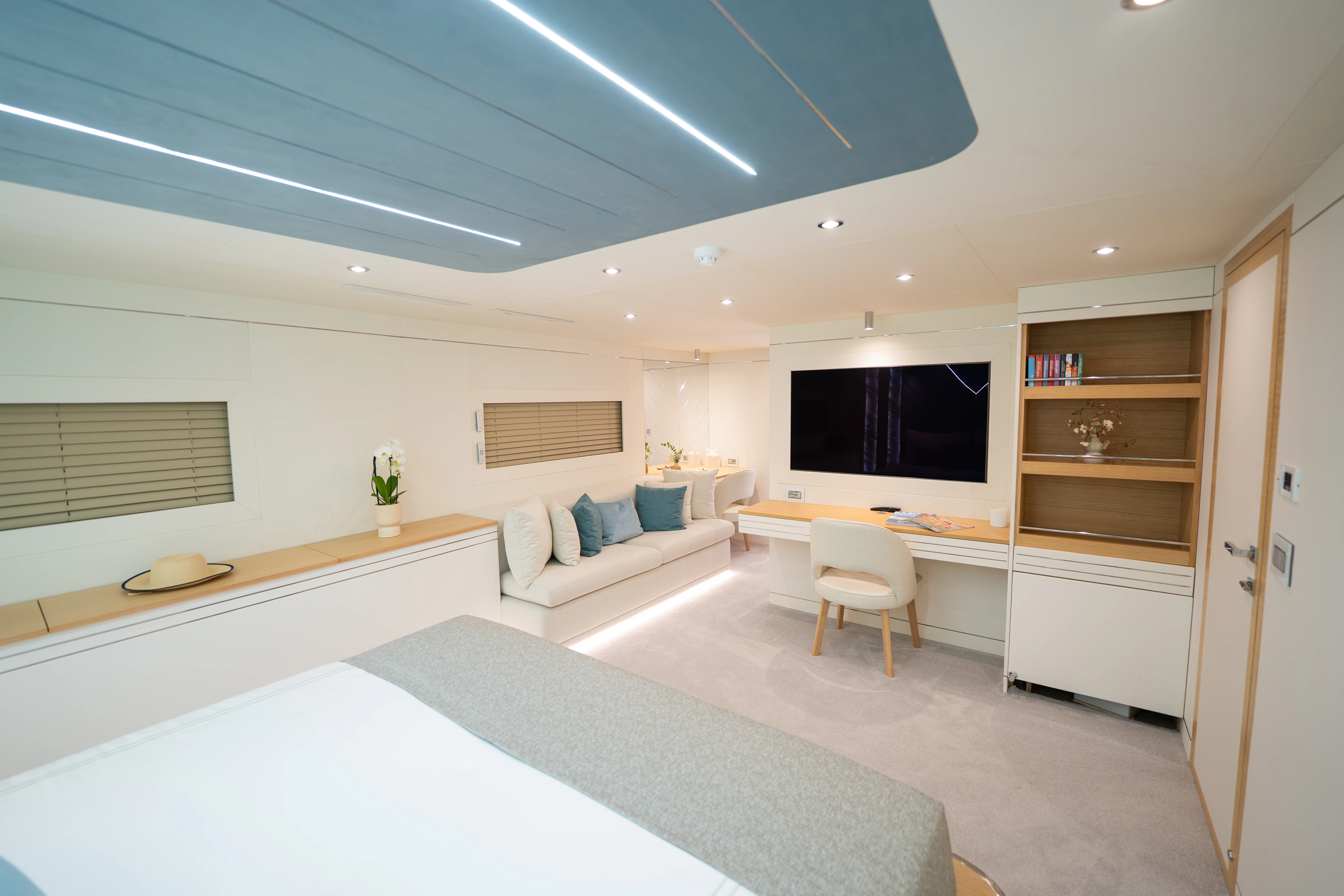 a room with a couch and a tv aboard RENATA Yacht for Charter