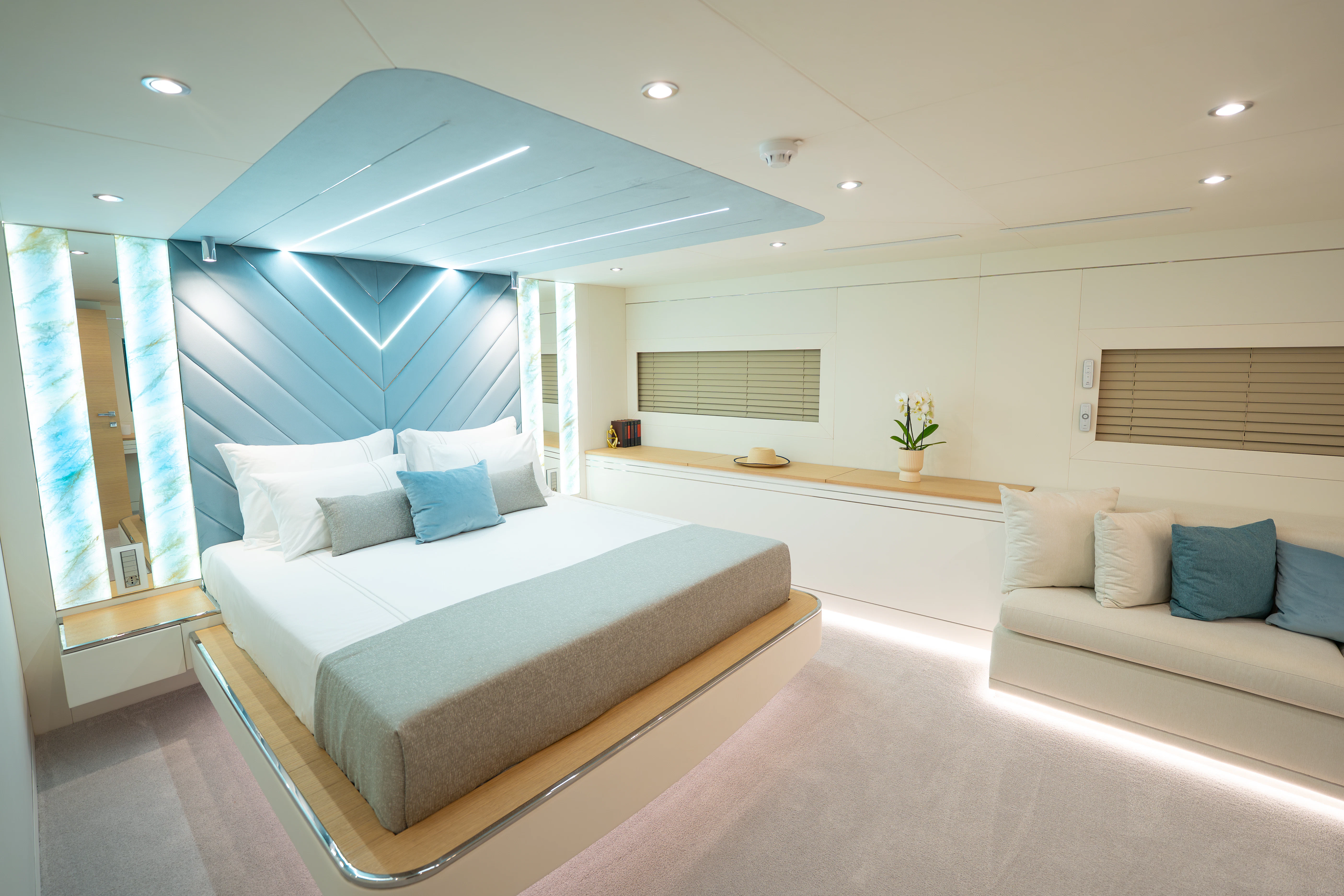 a room with a bed and a desk aboard RENATA Yacht for Charter