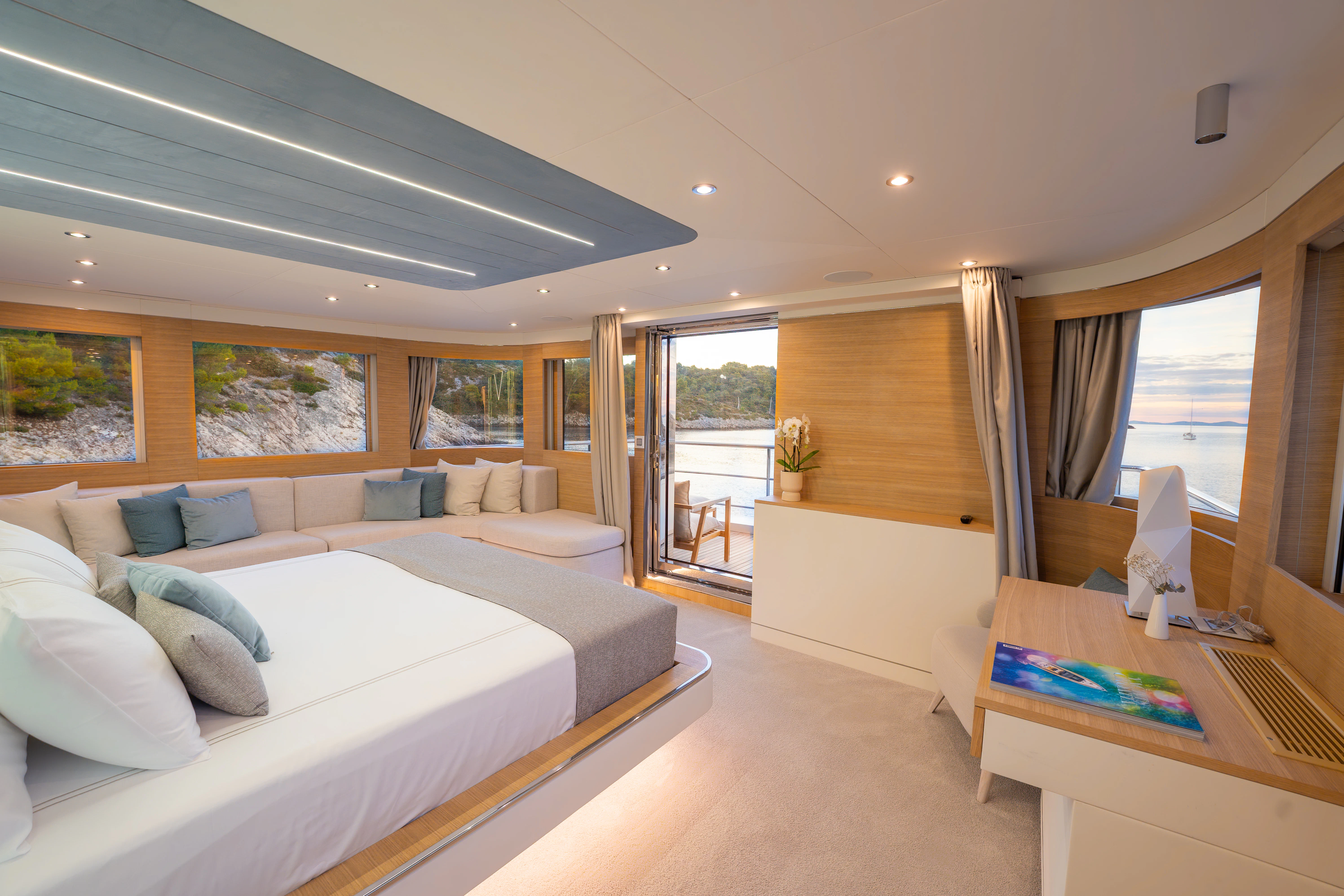 a room with a bed and a table aboard RENATA Yacht for Charter