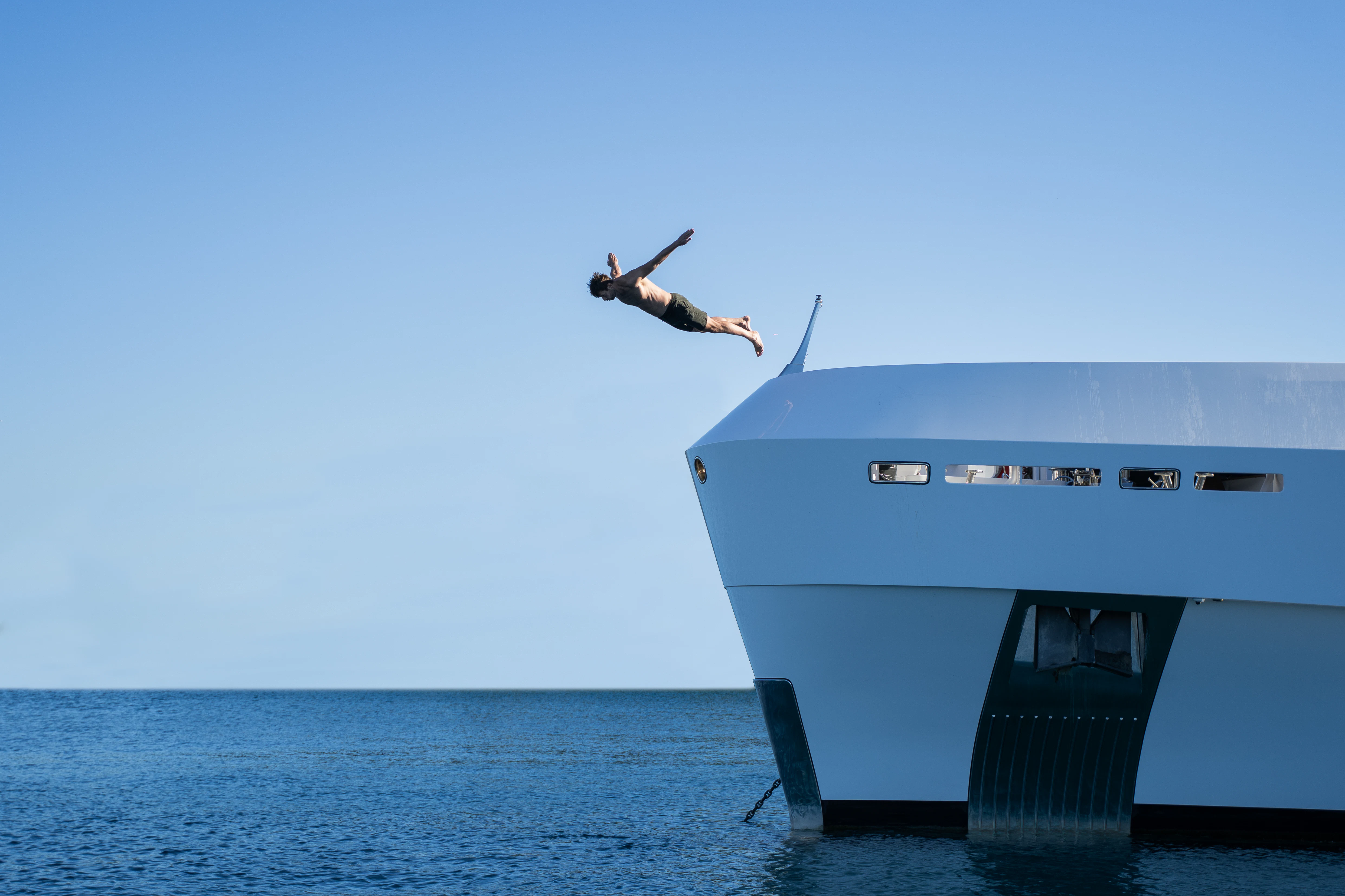 a person jumping off a boat aboard RENATA Yacht for Charter