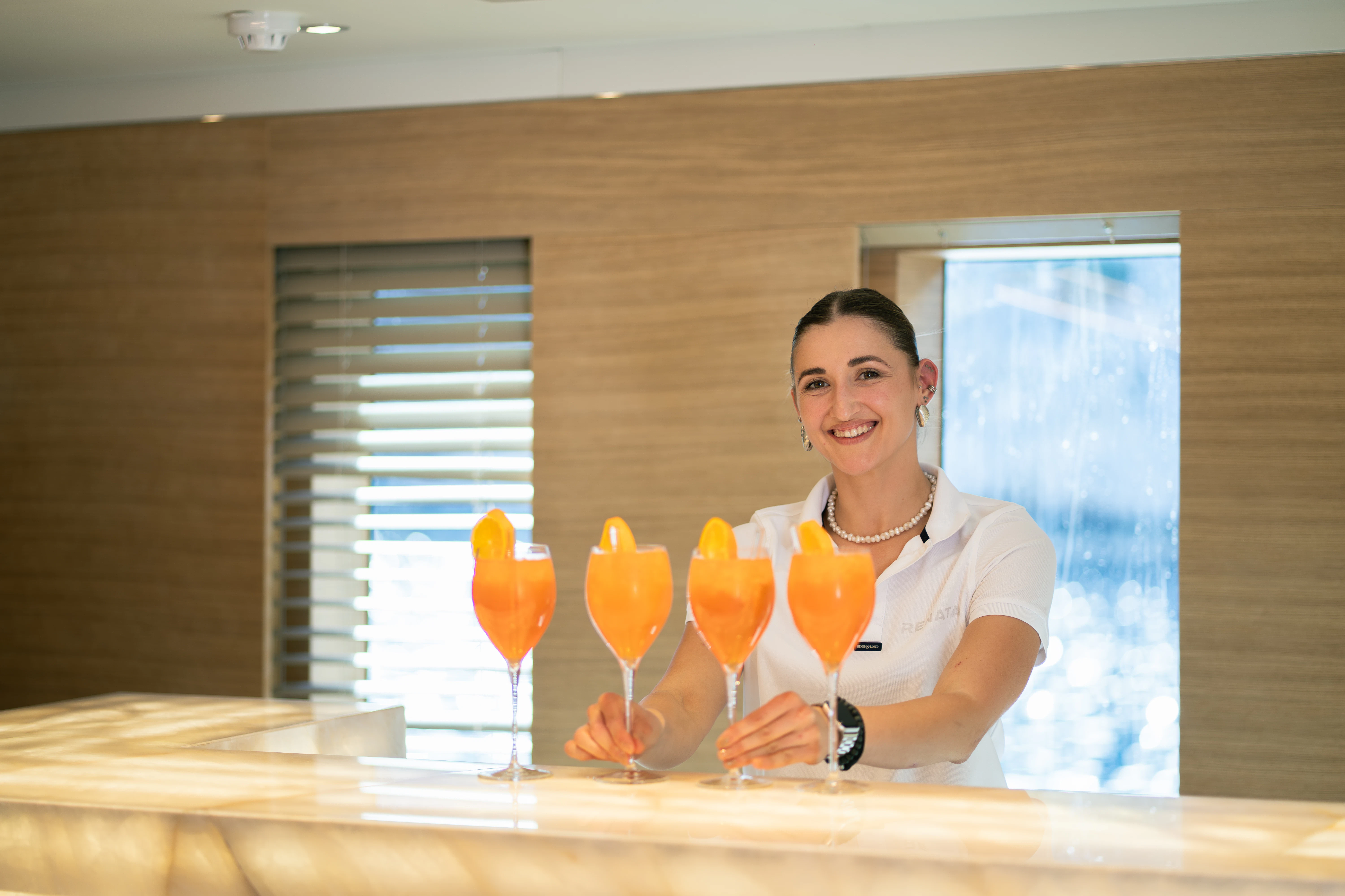 a person holding a glass of orange juice aboard RENATA Yacht for Charter