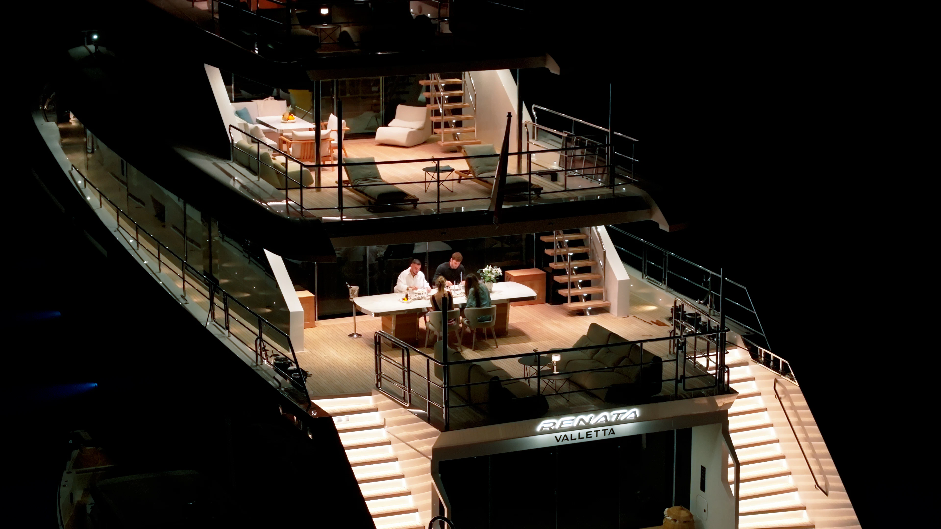 a group of people standing on a stage aboard RENATA Yacht for Charter