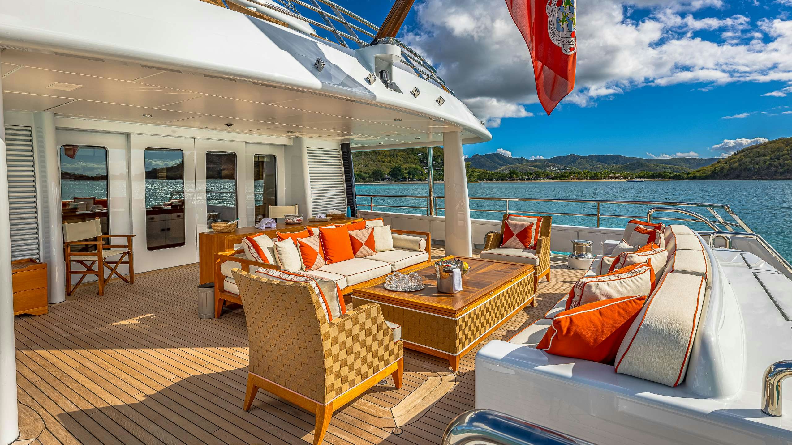 a deck with a table and chairs on it aboard DEEP BLUE Yacht for Charter