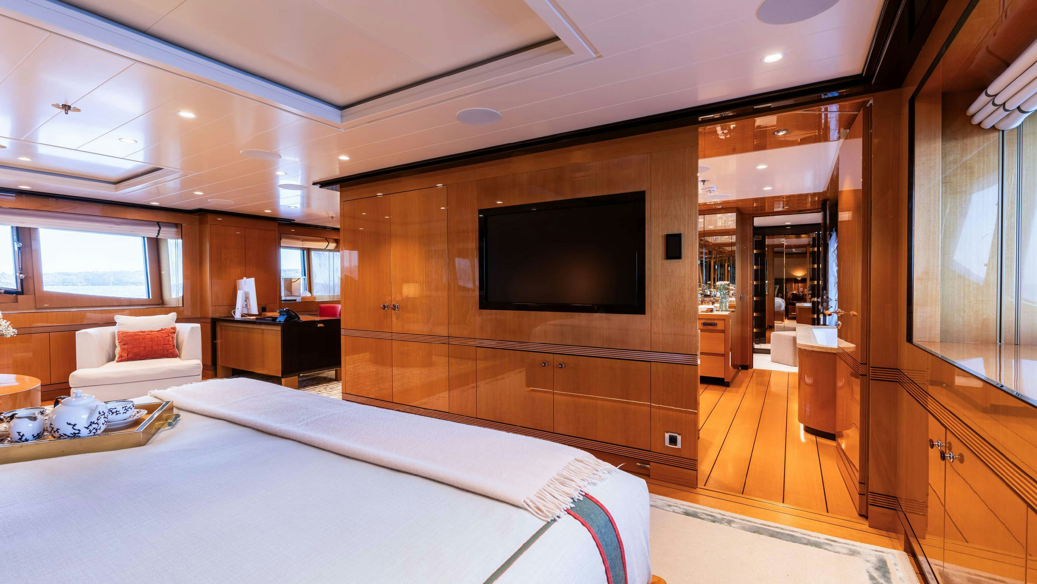 a large hotel room with a large bed and tv aboard DEEP BLUE Yacht for Charter