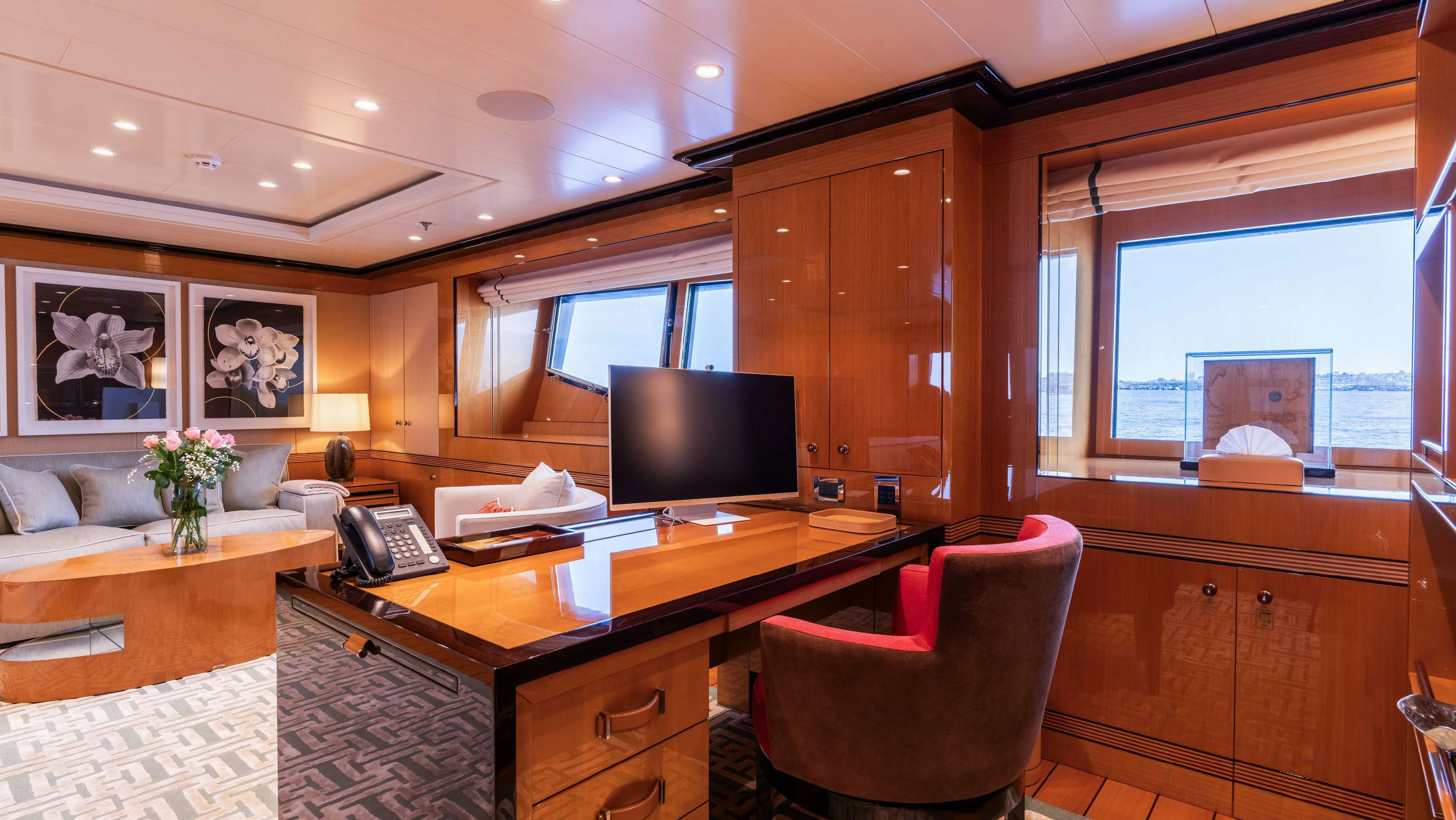 a room with a desk and a tv aboard DEEP BLUE Yacht for Charter