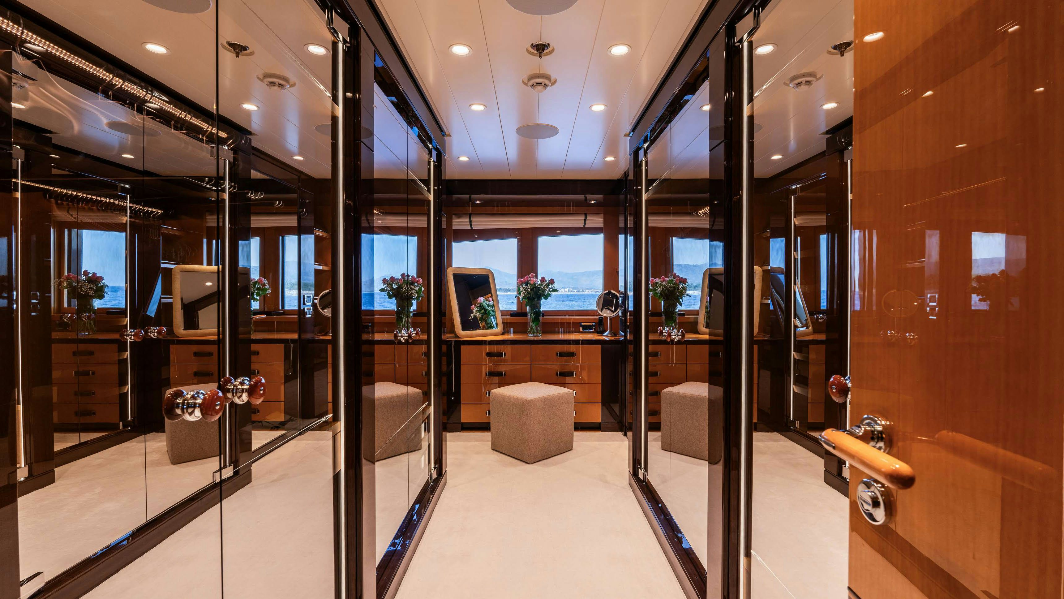 a room with glass walls and a glass wall with a desk and a computer on it aboard DEEP BLUE Yacht for Charter