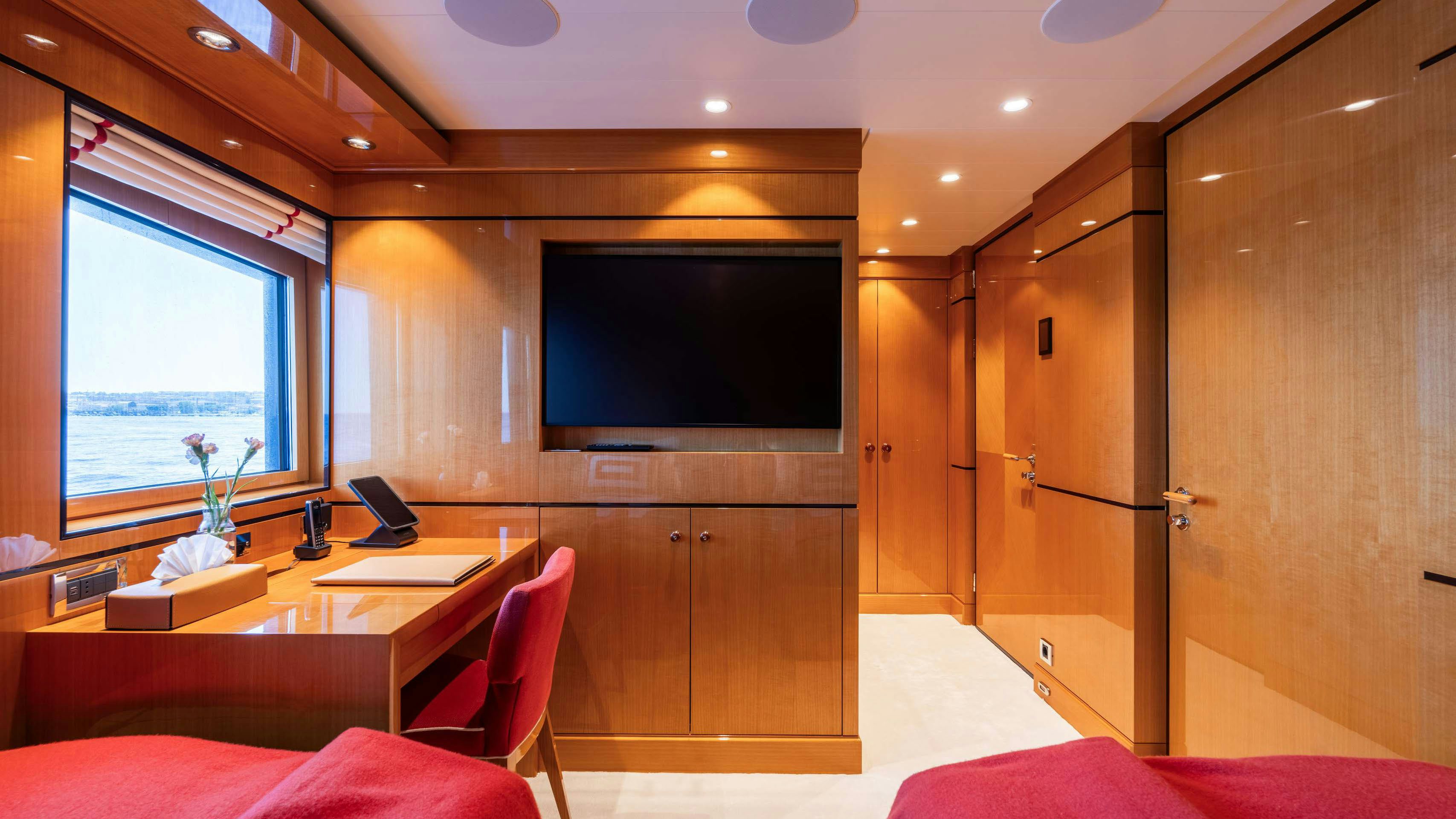 a room with a tv and a table aboard DEEP BLUE Yacht for Charter
