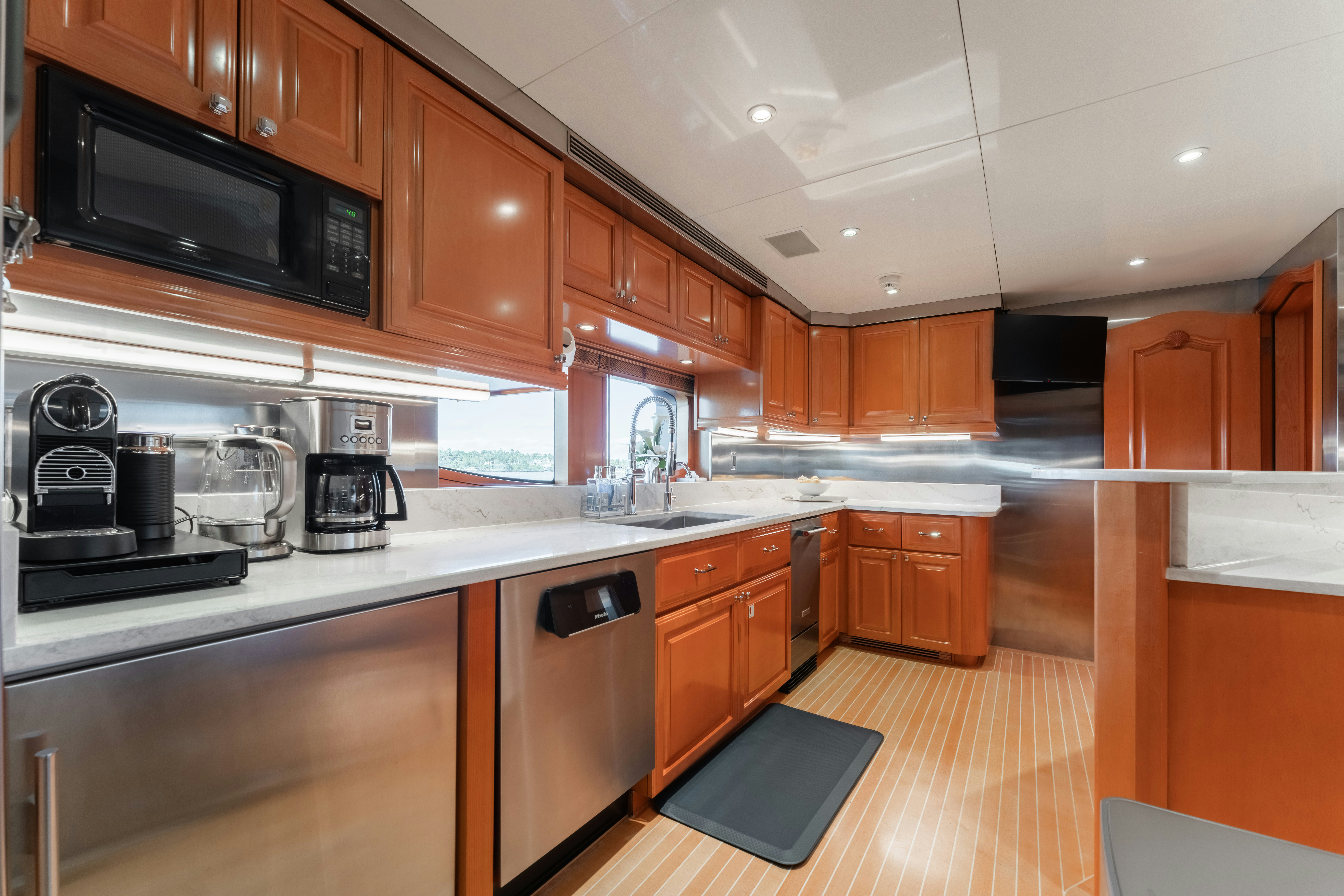 a kitchen with wooden cabinets aboard SUMMERDANCE Yacht for Sale