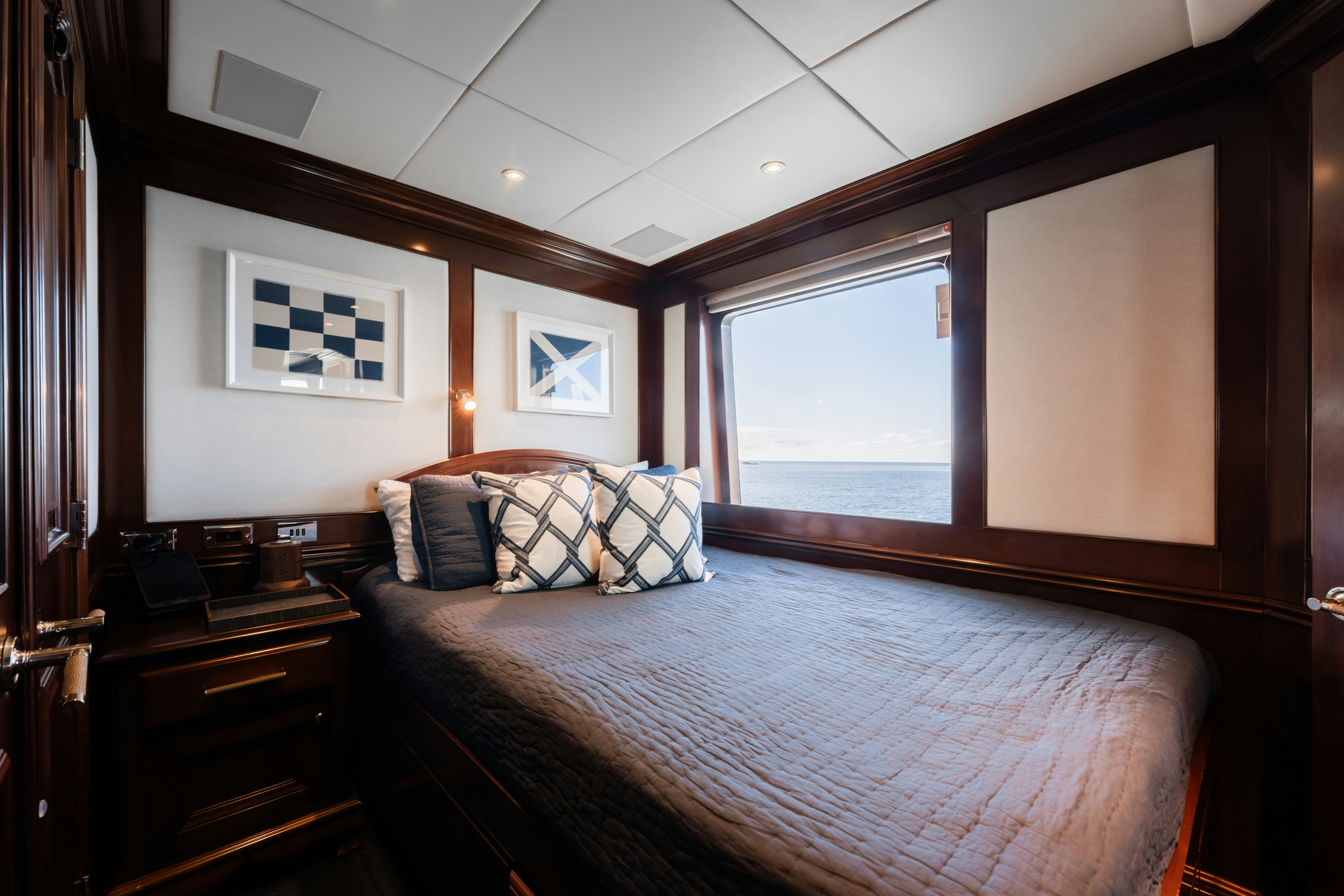 a bed with a large mirror above it aboard SUMMERDANCE Yacht for Sale