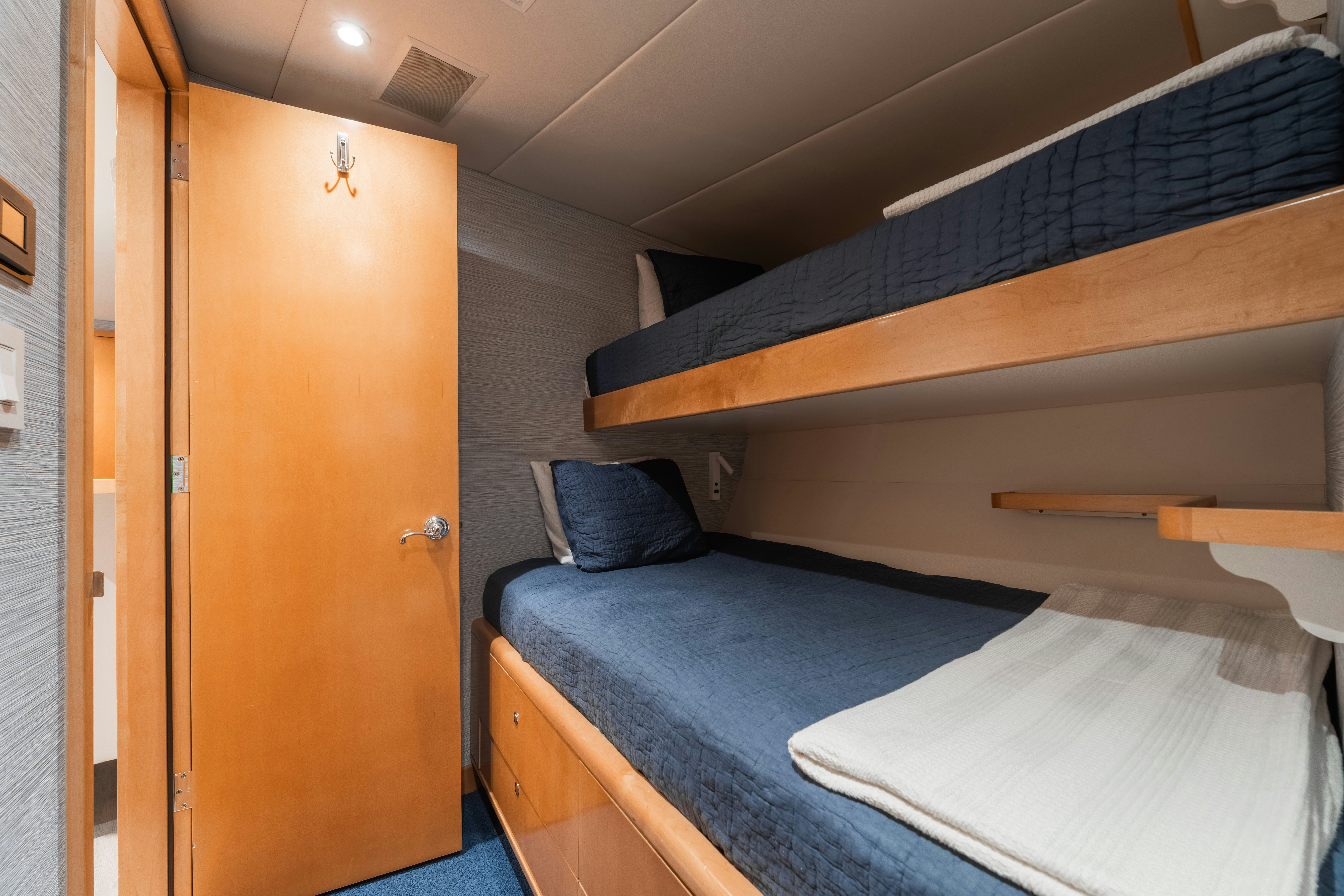a room with a bed and a door aboard SUMMERDANCE Yacht for Sale