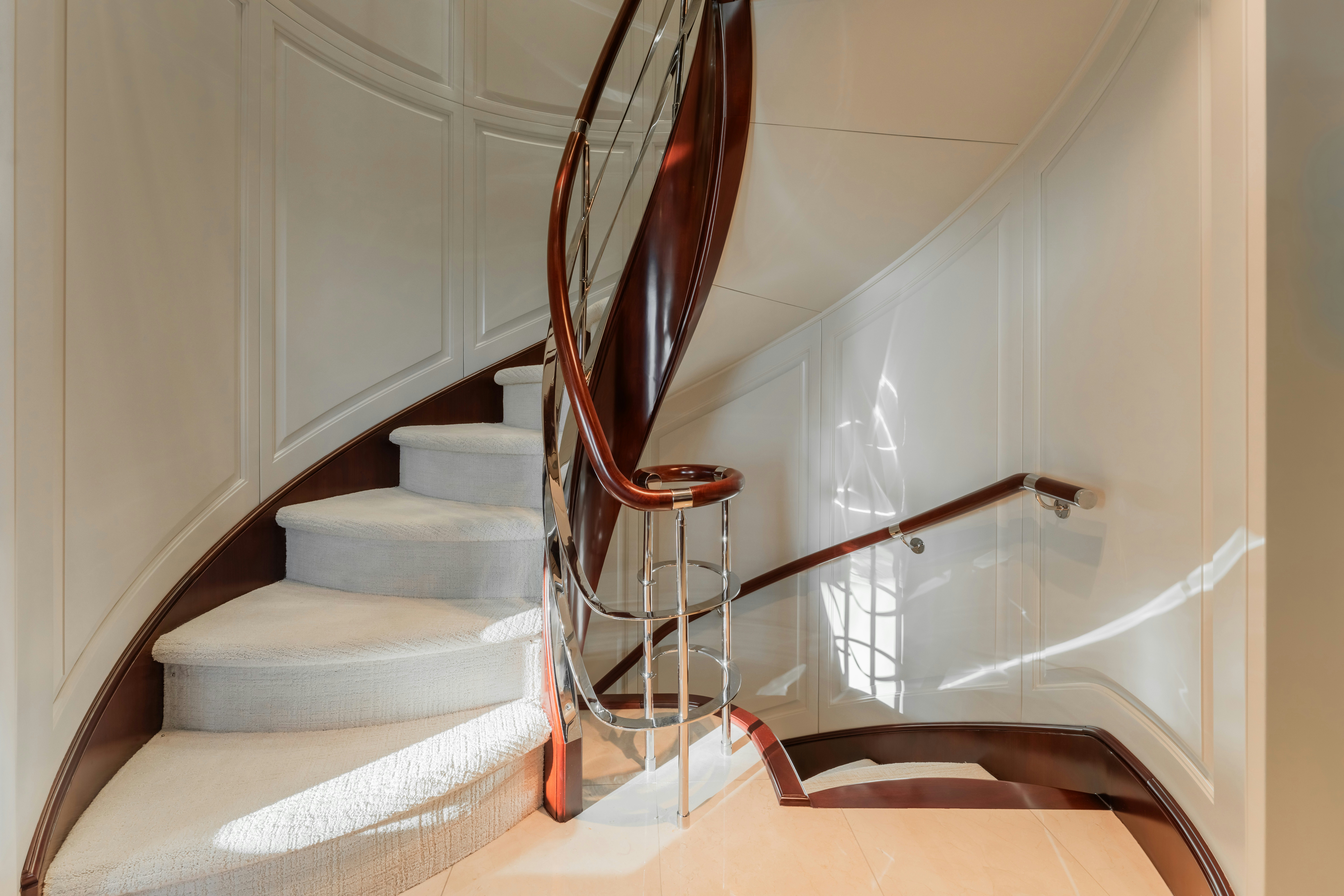 a staircase with a red and white staircase and a red spiral staircase aboard SUMMERDANCE Yacht for Sale