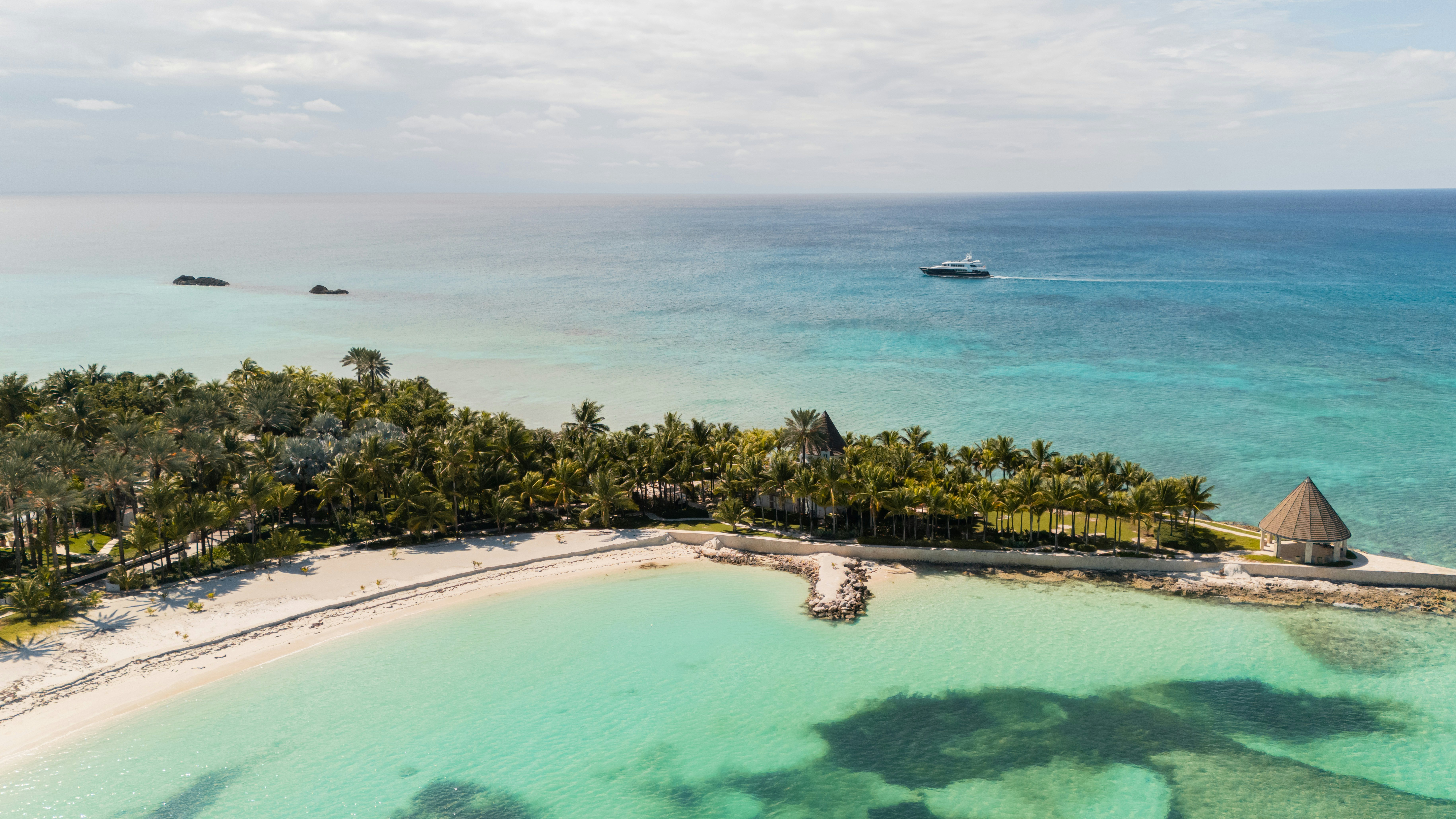 a large pool with trees and a boat in the background aboard SUMMERDANCE Yacht for Charter