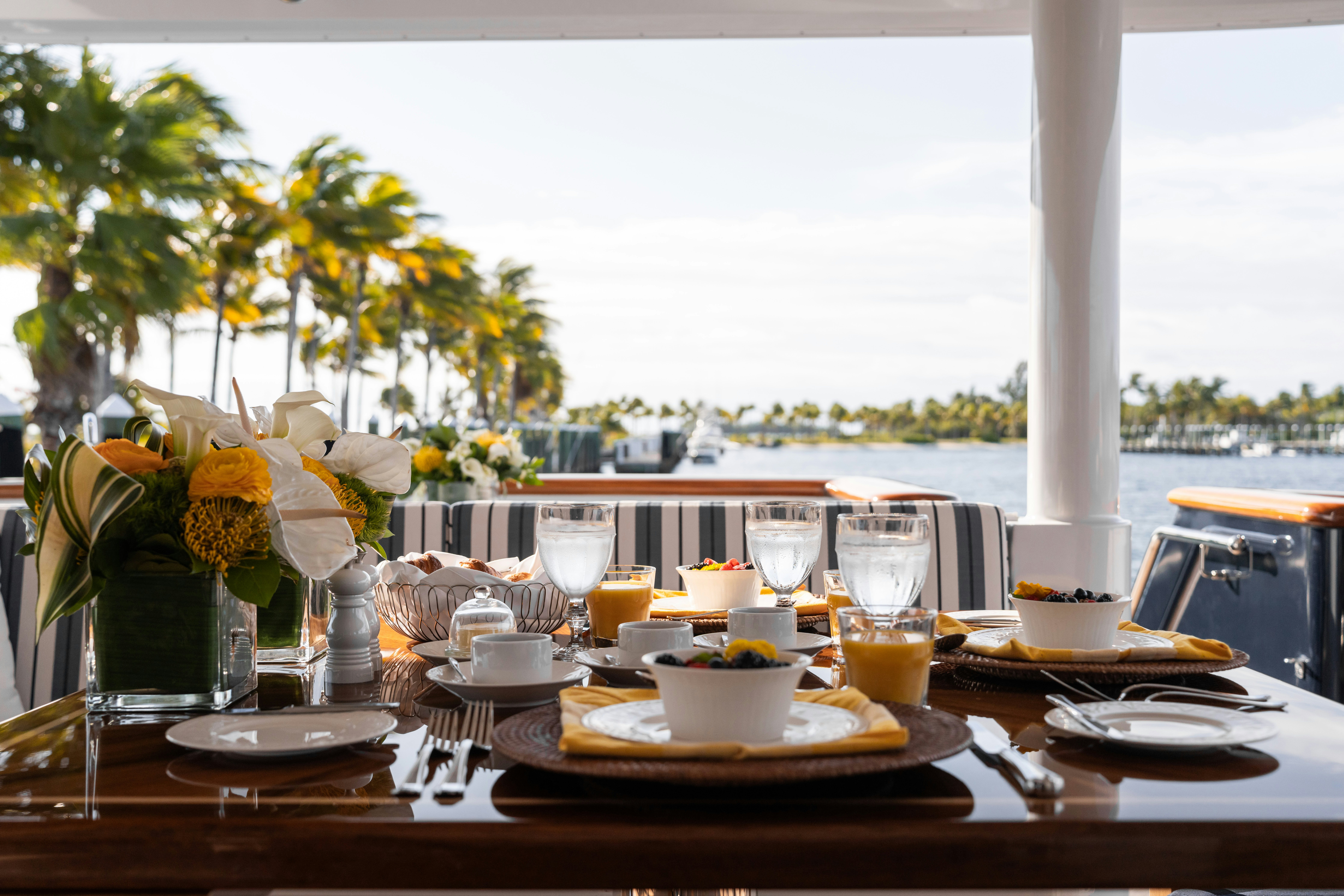 a table with plates and glasses aboard SUMMERDANCE Yacht for Charter
