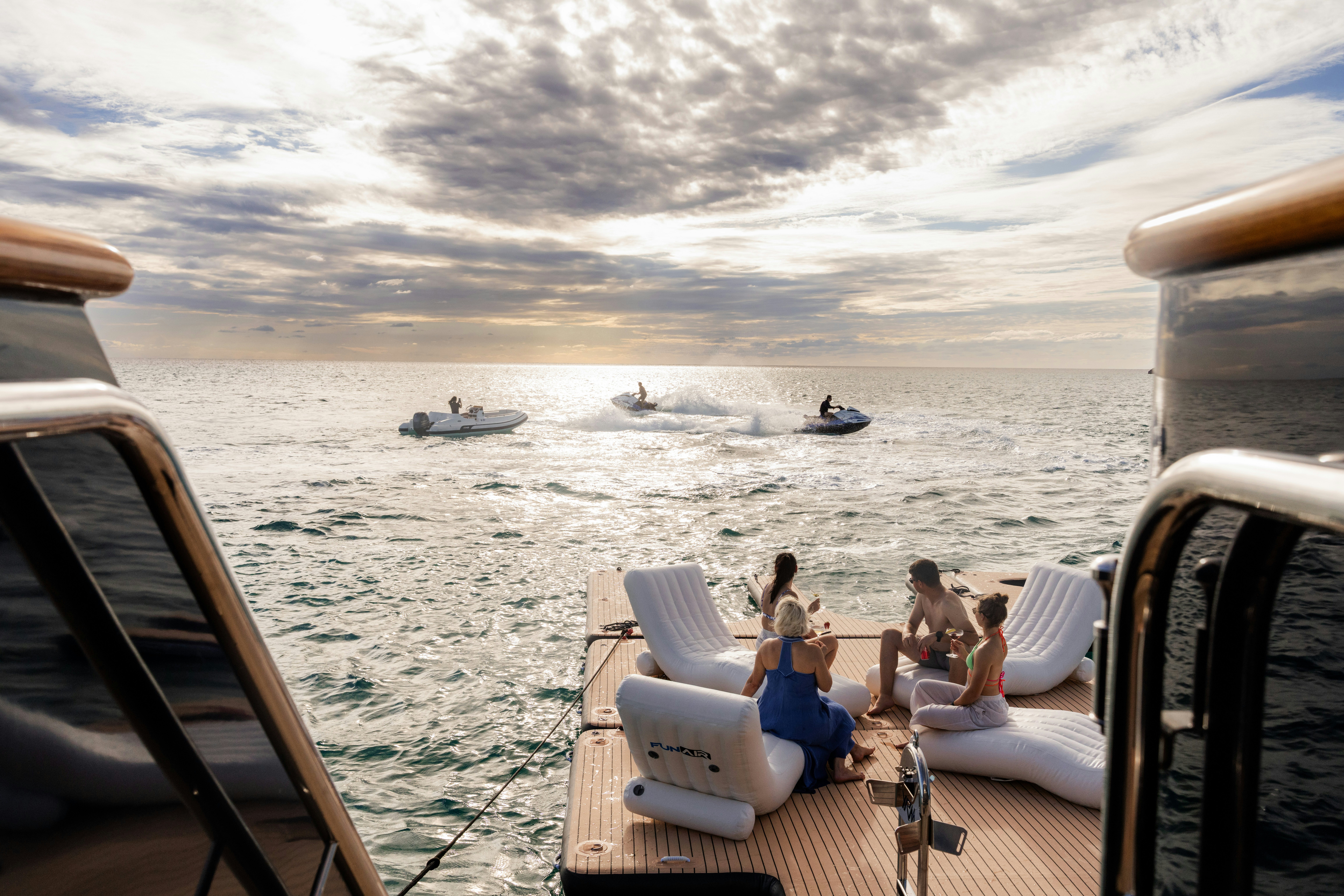 people sitting on a deck overlooking the water aboard SUMMERDANCE Yacht for Charter