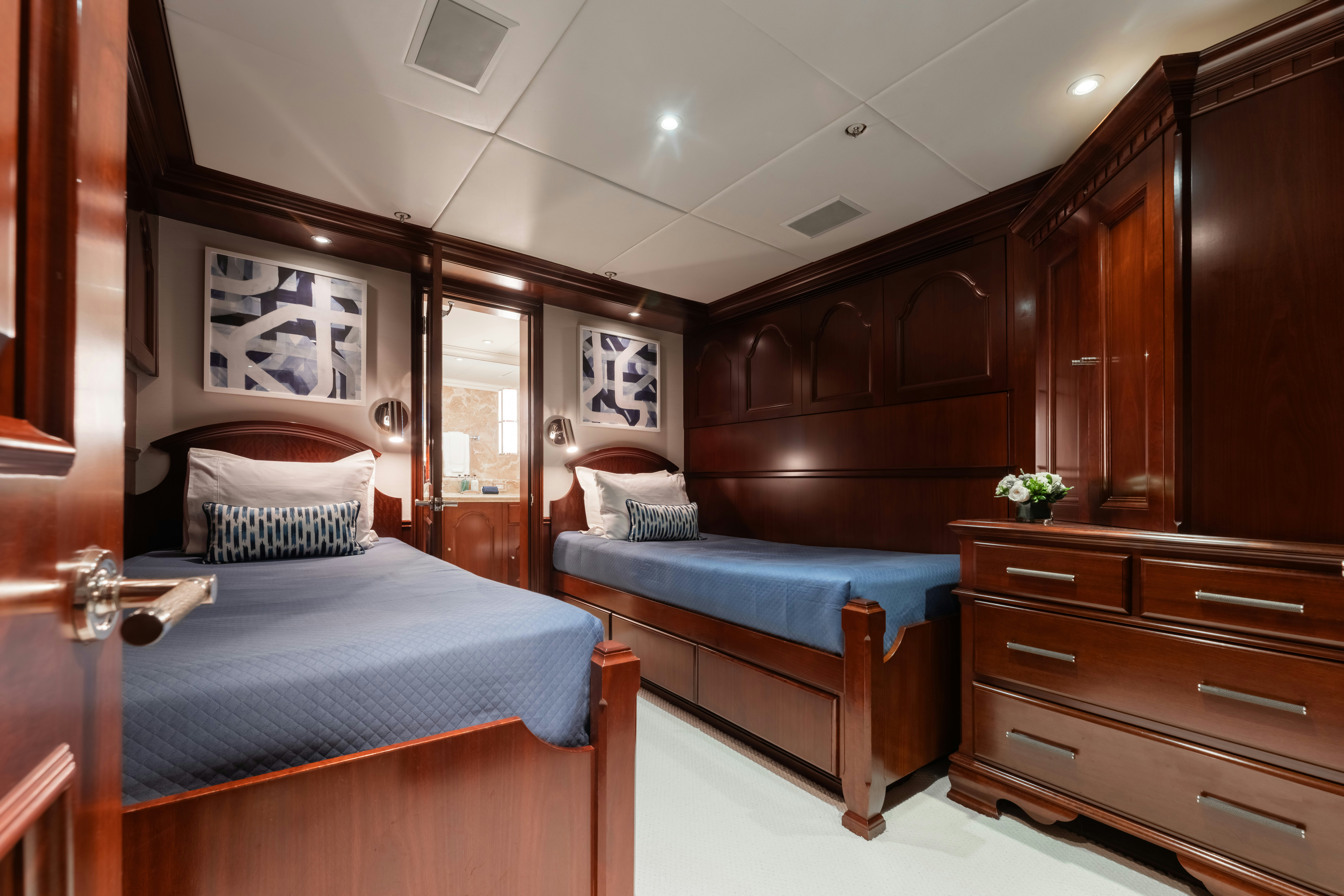 a bedroom with wooden furniture aboard SUMMERDANCE Yacht for Charter