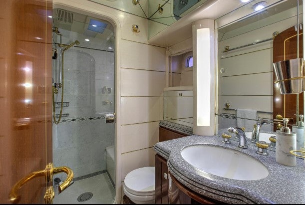 a bathroom with a glass shower aboard SORCERER II Yacht for Sale