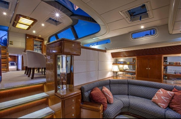 a living room with a couch and a tv aboard SORCERER II Yacht for Sale