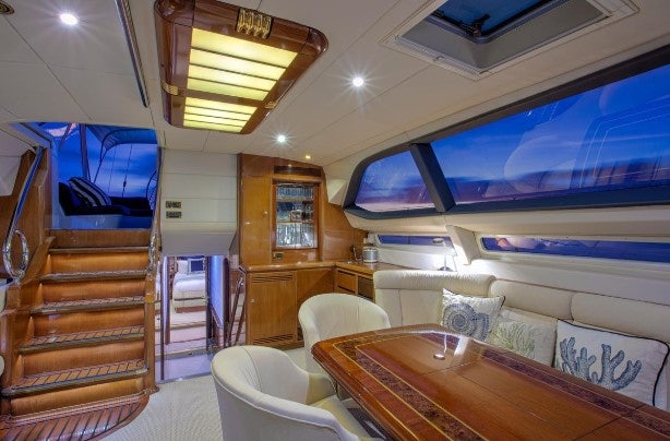 a room with a table and chairs aboard SORCERER II Yacht for Sale