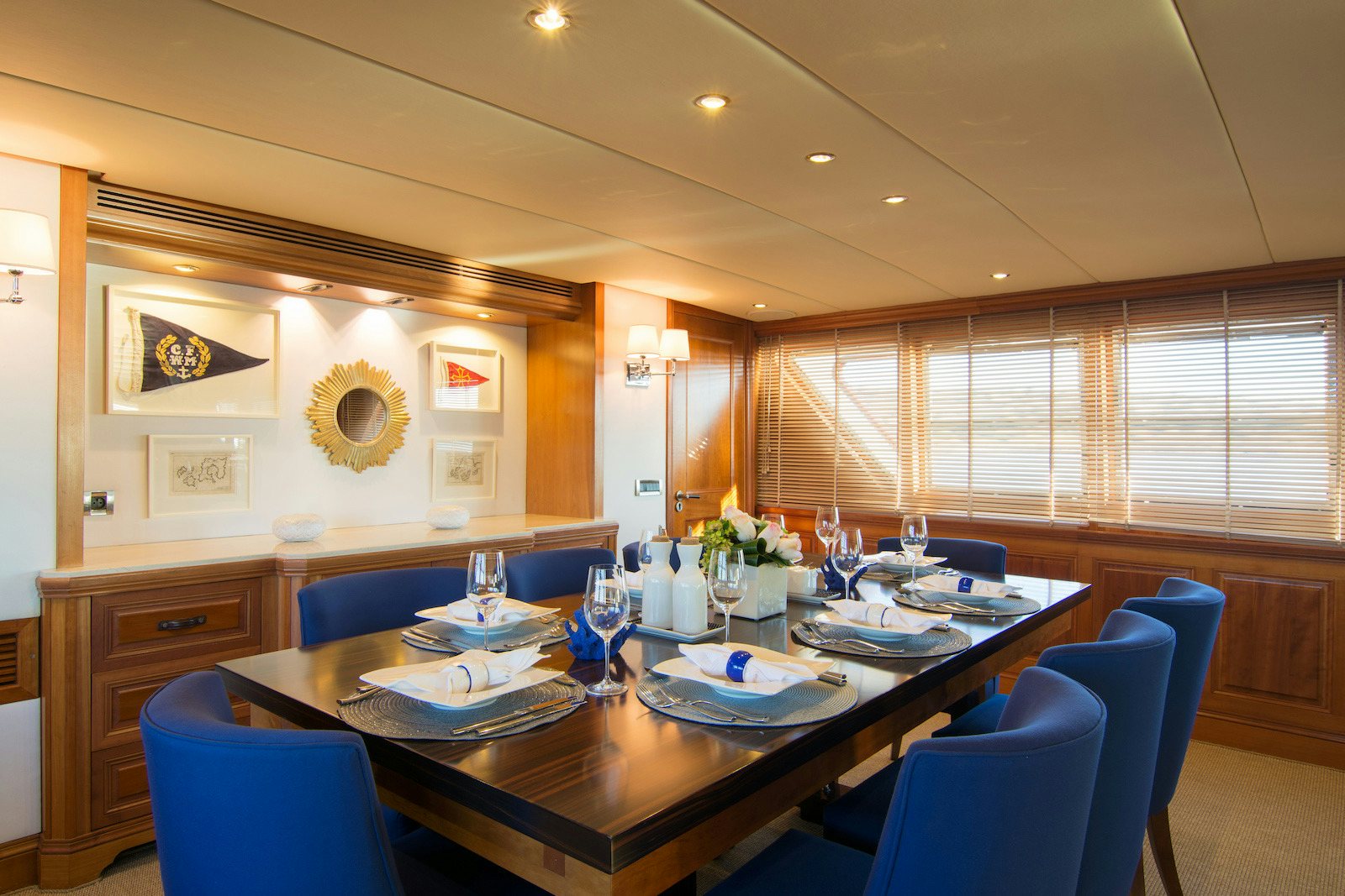 a dining room with blue chairs aboard PARVATI Yacht for Sale