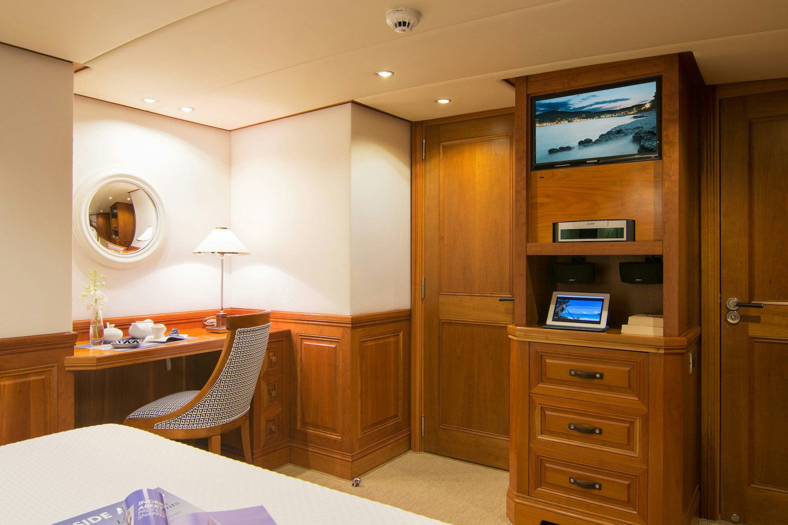 a room with a desk and a tv on the wall aboard PARVATI Yacht for Sale
