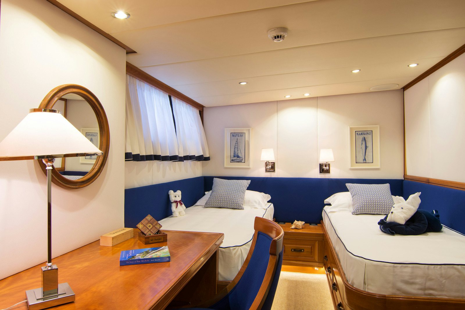 a bedroom with a bed and a desk aboard PARVATI Yacht for Sale