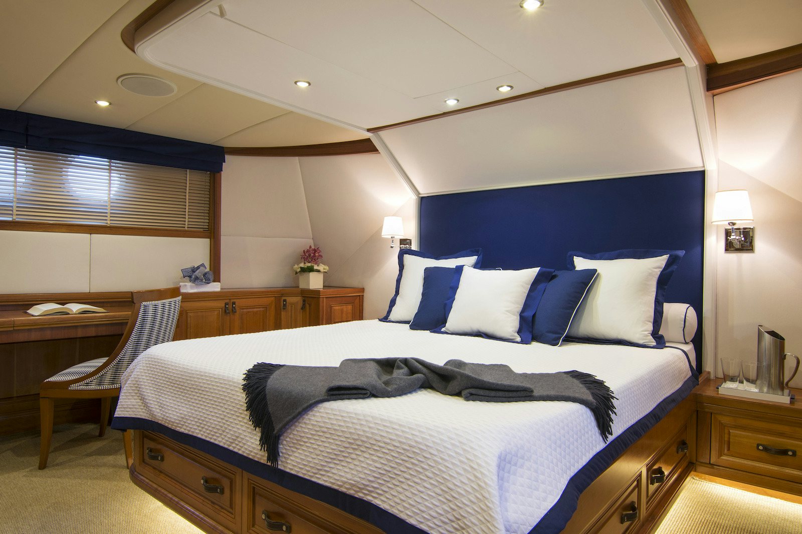 a bedroom with a blue bed aboard PARVATI Yacht for Sale