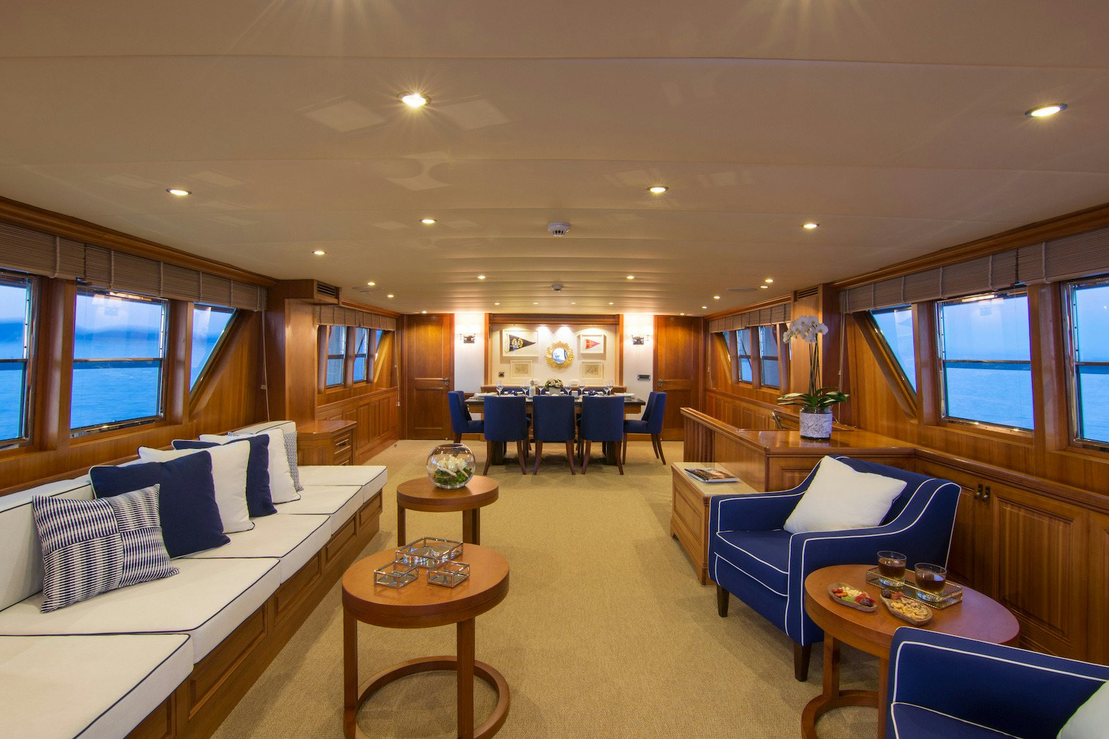 a living room with a bed and a table aboard PARVATI Yacht for Sale