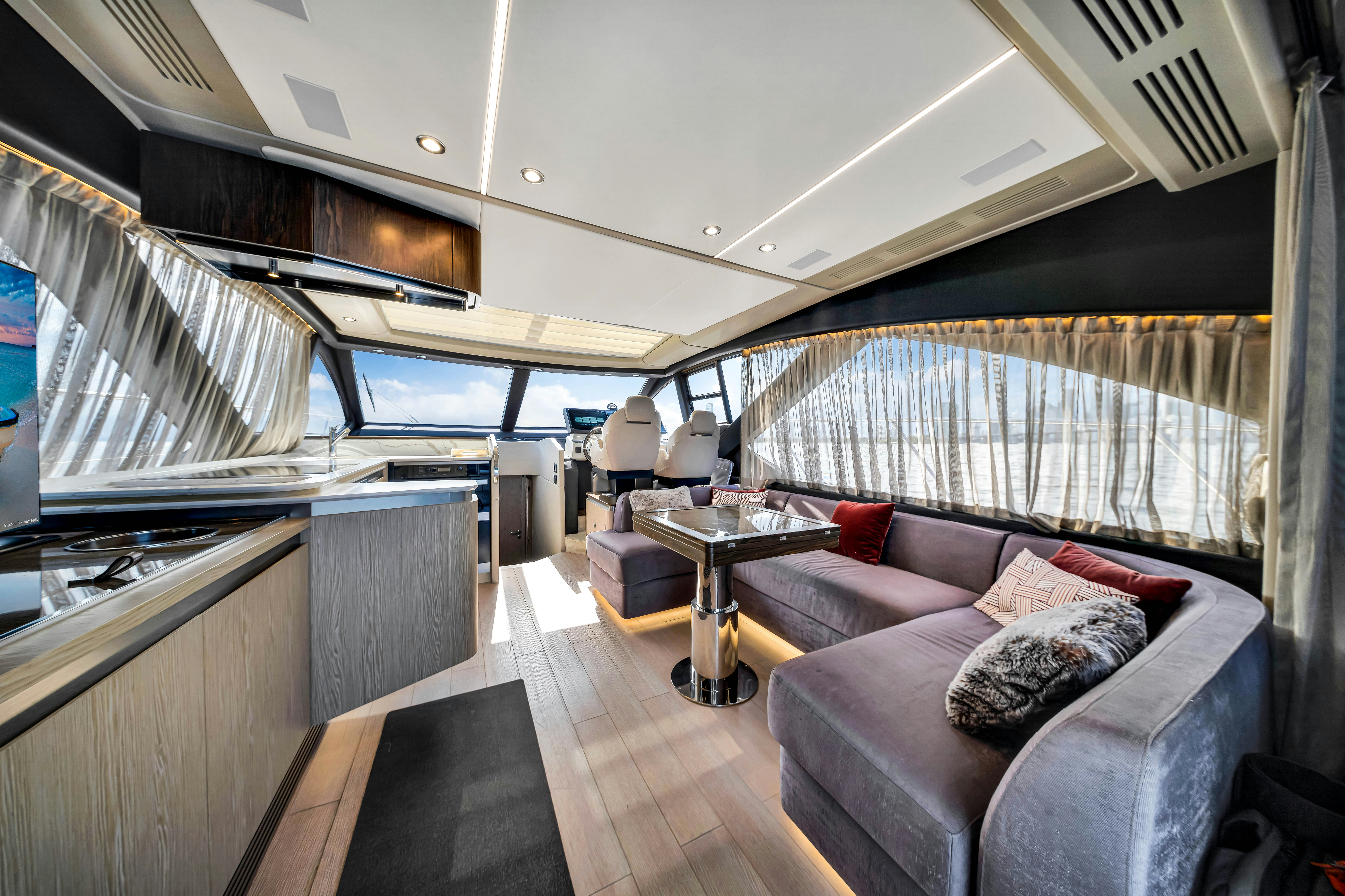 a living room with a couch and a table aboard AMF Yacht for Sale