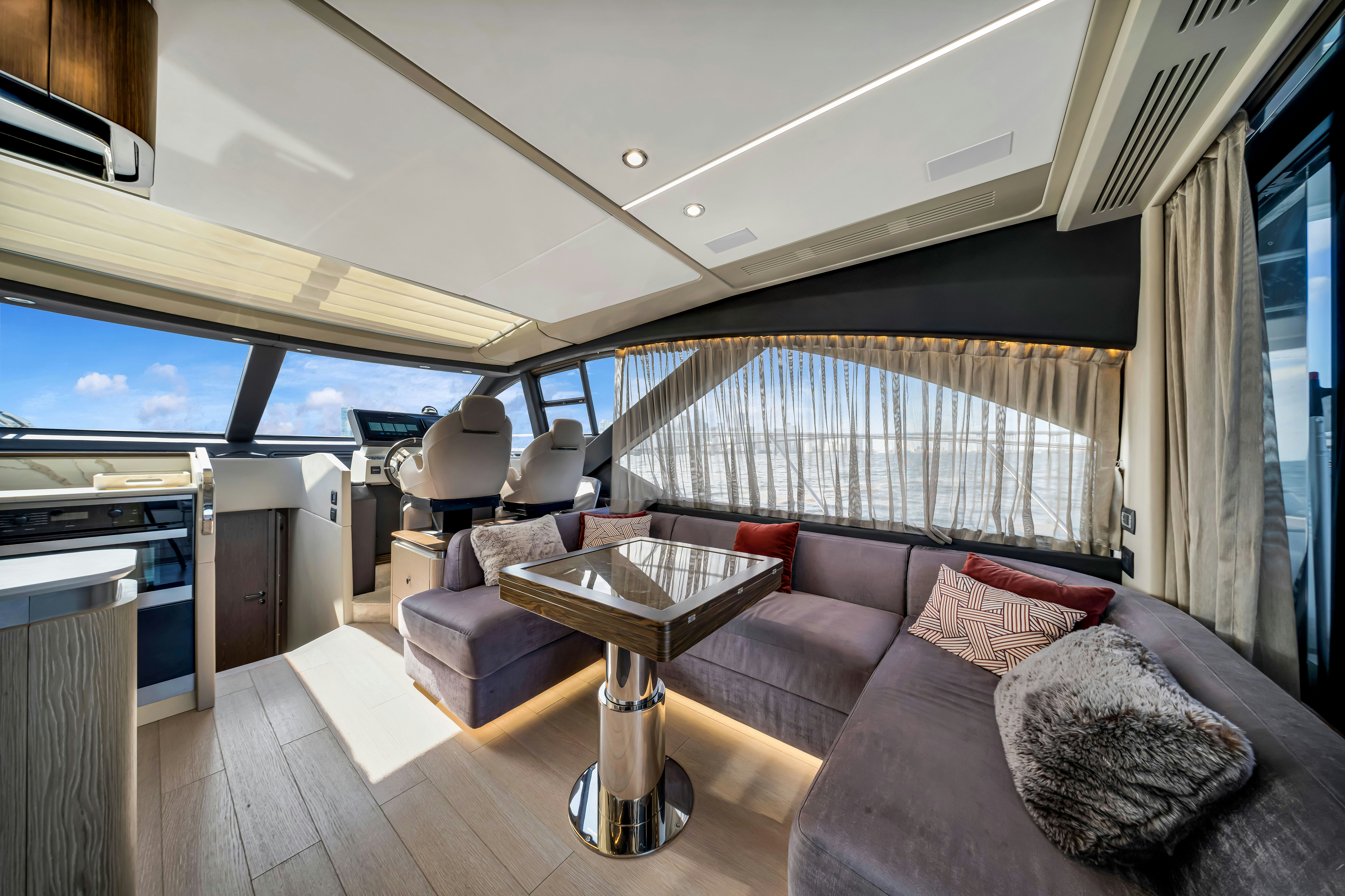 a living room with a couch and a table aboard AMF Yacht for Sale